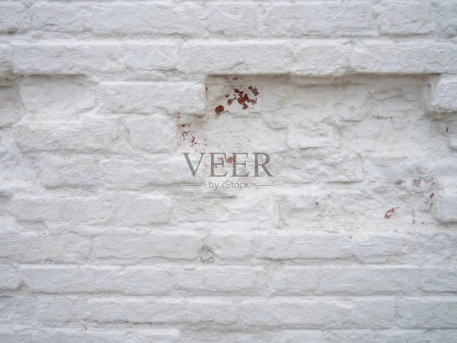 旧的,不均匀的砖石。墙坑,刷白的砖照片摄影图片