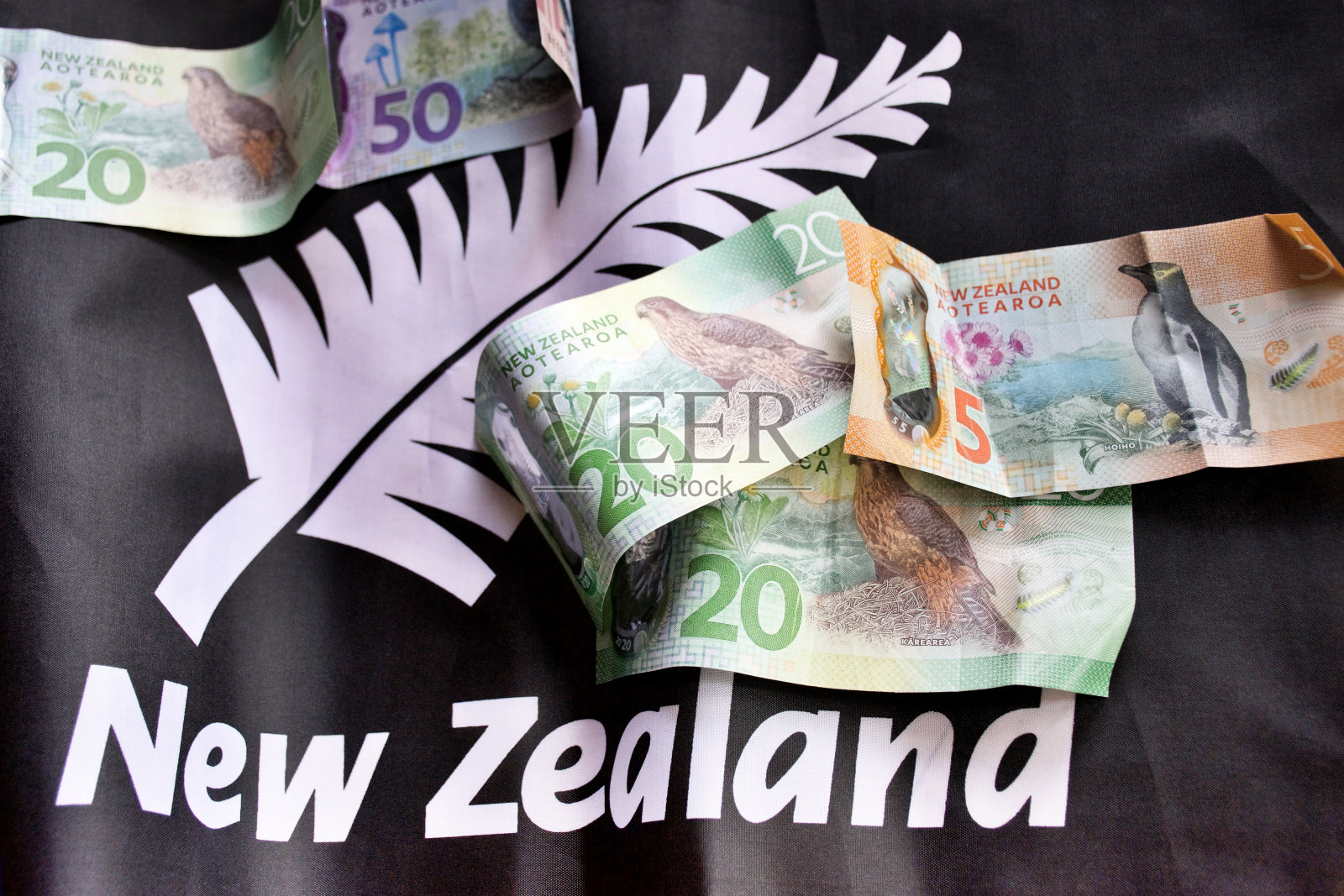 有新西兰国旗背景的新西兰货币(NZD)照片摄影图片