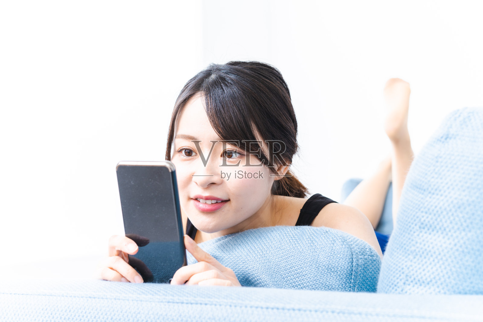 一个年轻女子穿着内衣用手机照片摄影图片