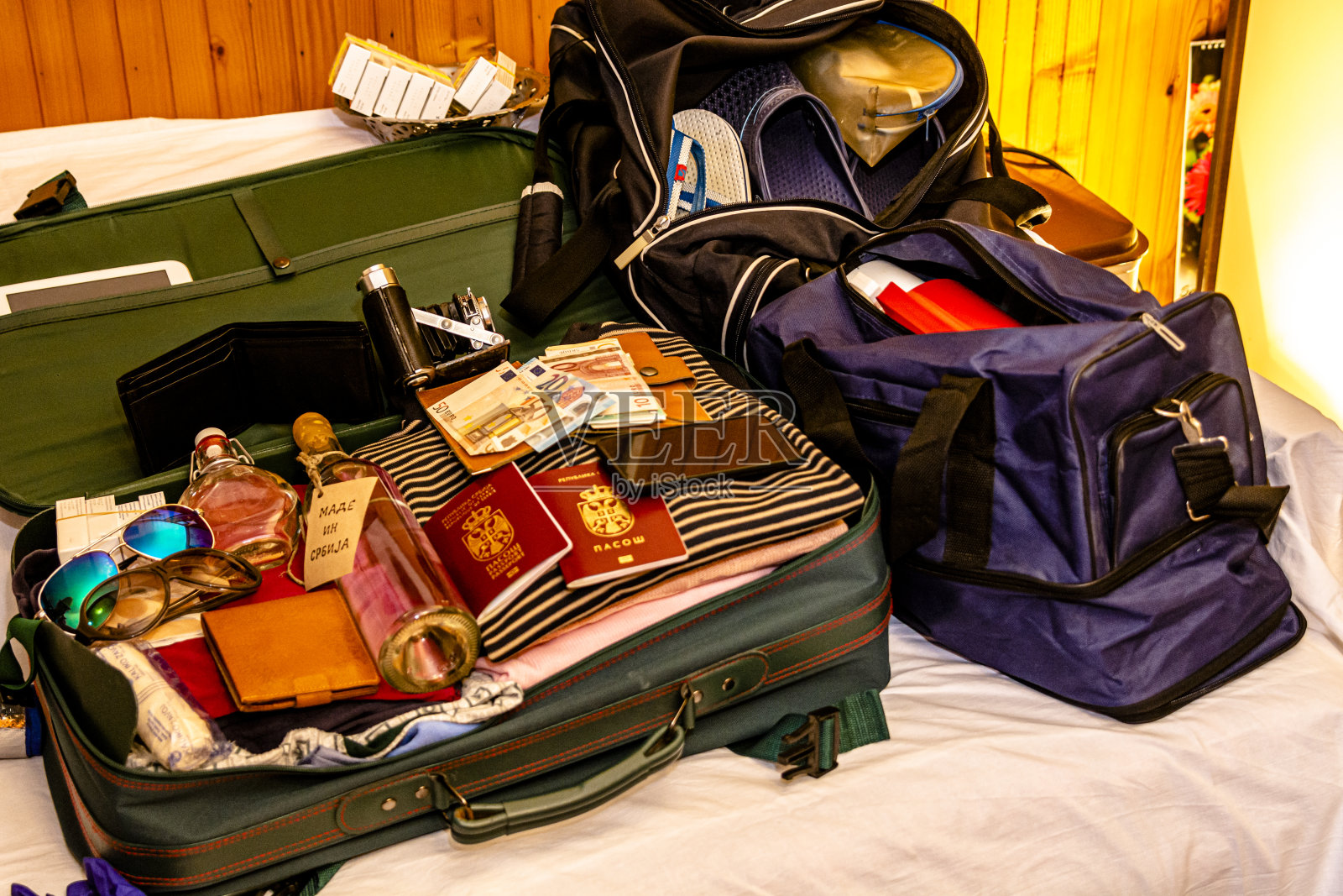 一个装满东西的手提箱和两本准备去度假的护照。照片摄影图片