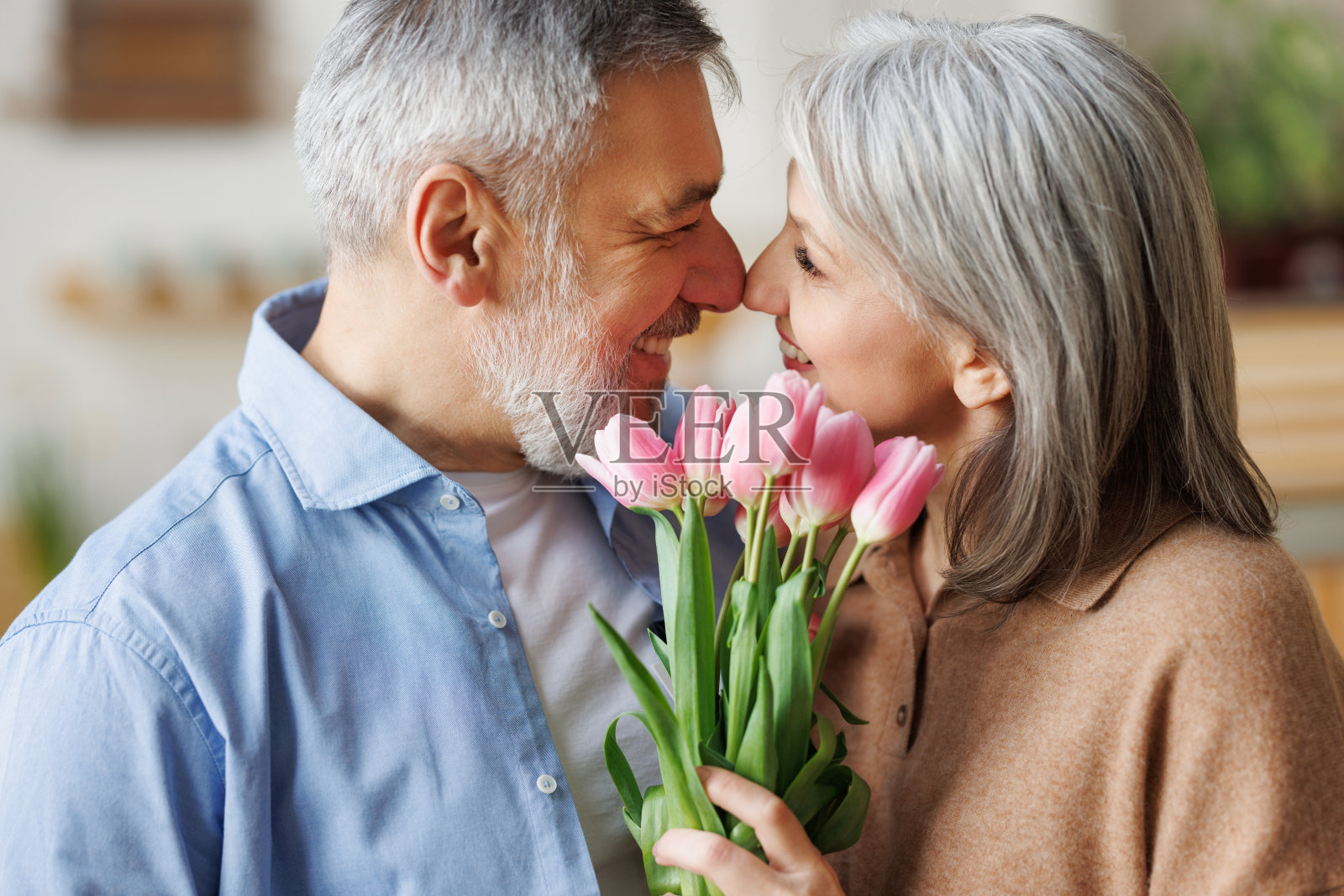 3月8日,爱你的老丈夫在家里送给妻子一束新鲜的粉红色郁金香,祝贺你照片摄影图片