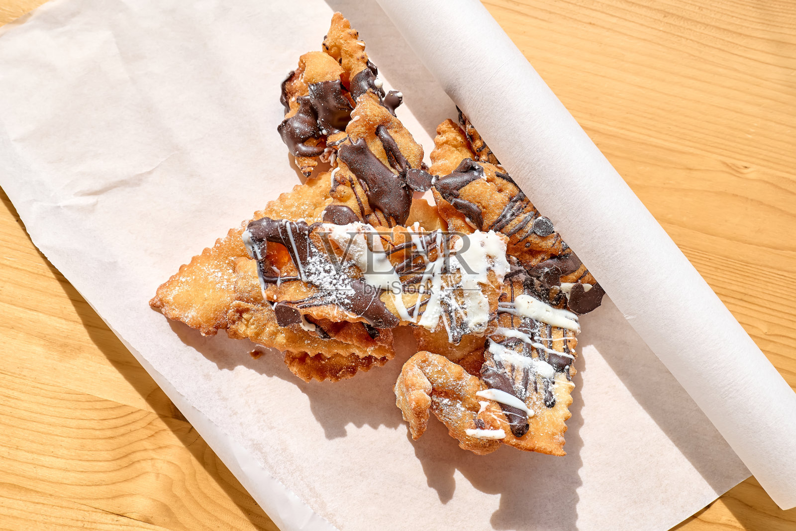 意大利嘉年华糖果。Sfrappole或chiacchiere——传统的甜酥面饼,油炸后撒上糖粉,在狂欢节星期四食用。照片摄影图片