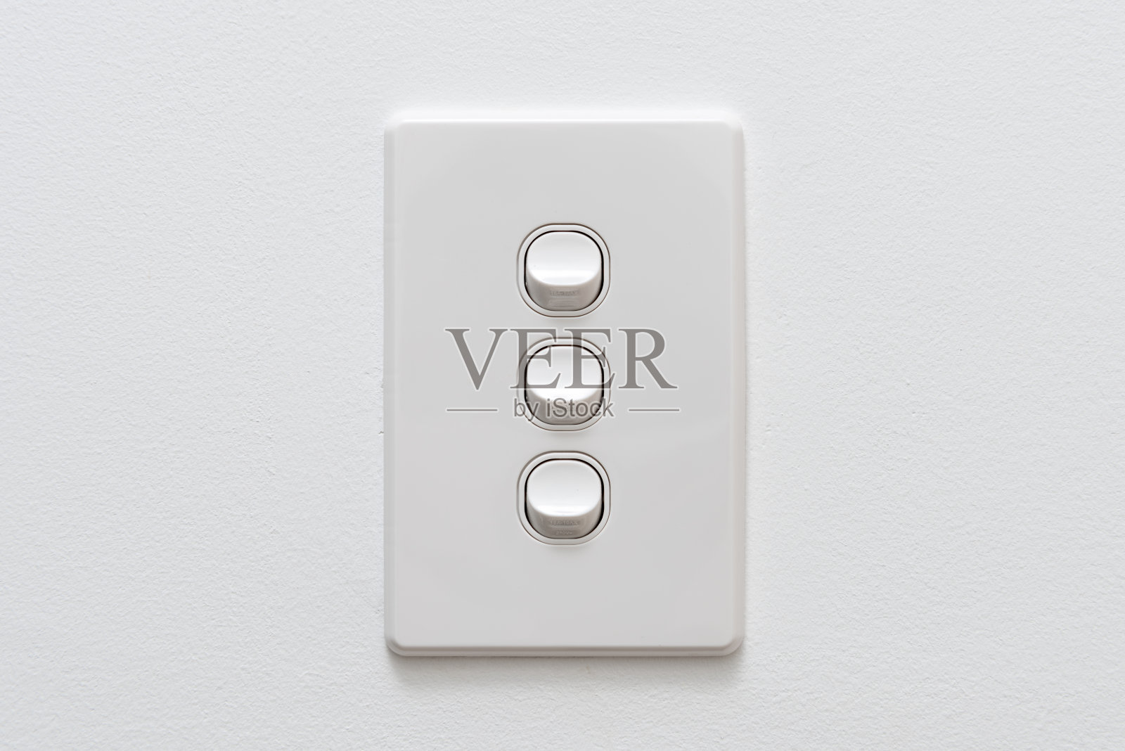 三帮白光开关在墙上照片摄影图片