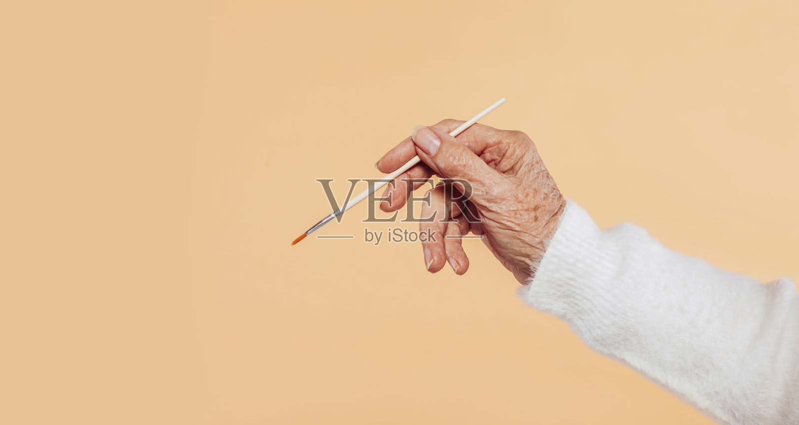 奶奶手里拿着刷子照片摄影图片