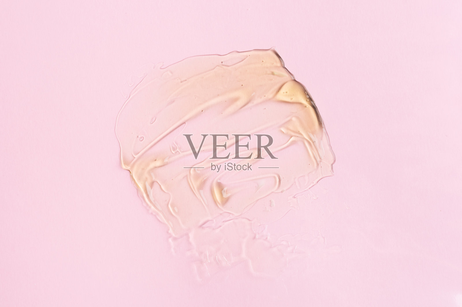 液体凝胶化妆品与泡沫粉红色的背景照片摄影图片