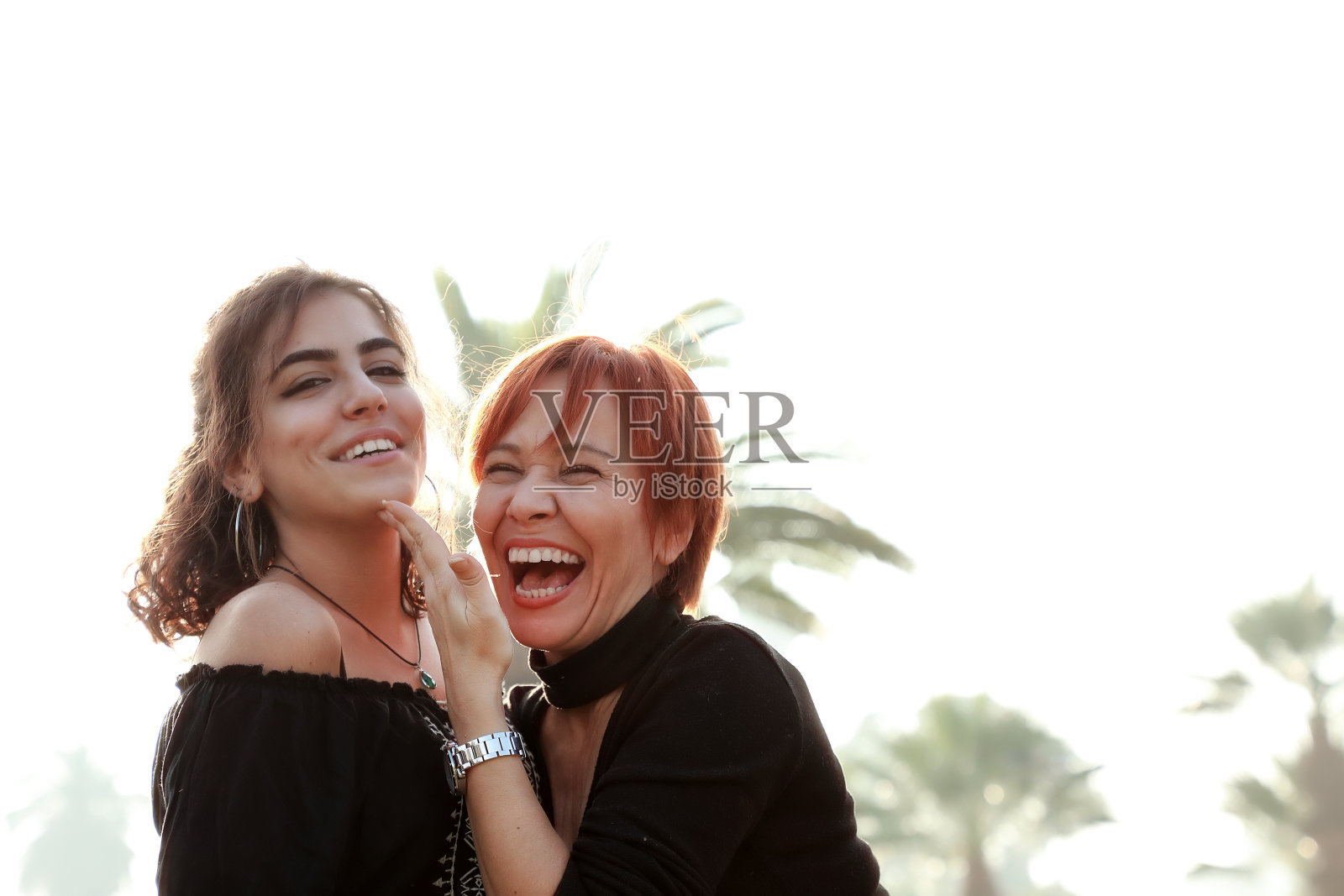 快乐的单身母亲和年轻的成年女儿在公园的户外肖像照片摄影图片