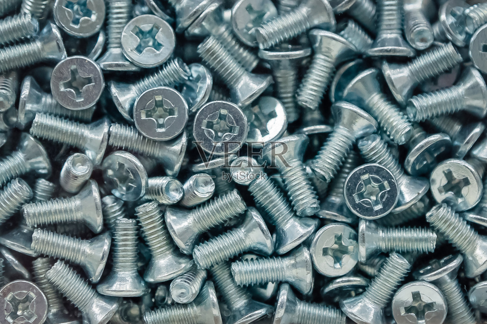 大量螺丝钉的图案。带十字形帽的短螺栓背景照片摄影图片