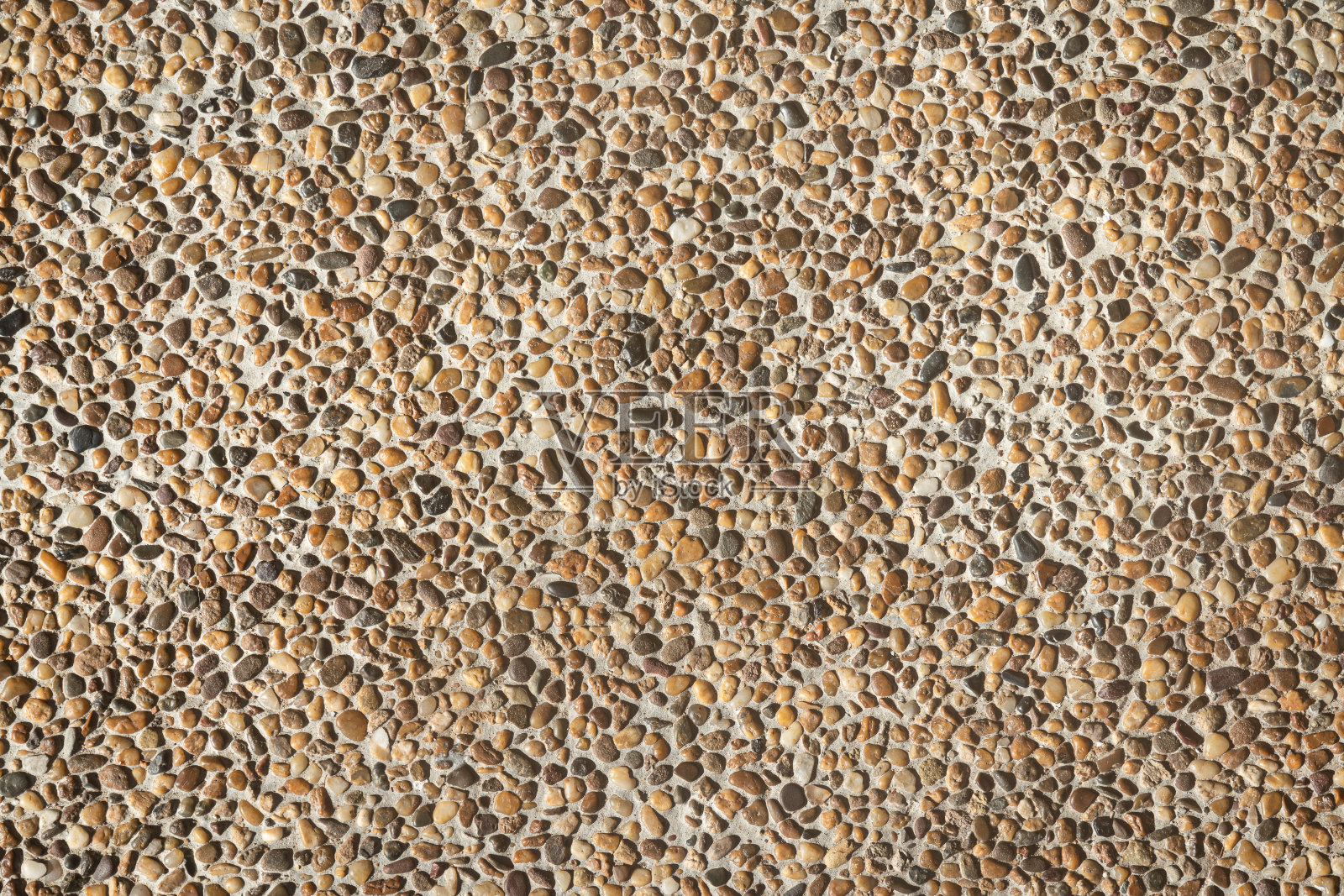 砾石或卵石石材表面。照片摄影图片