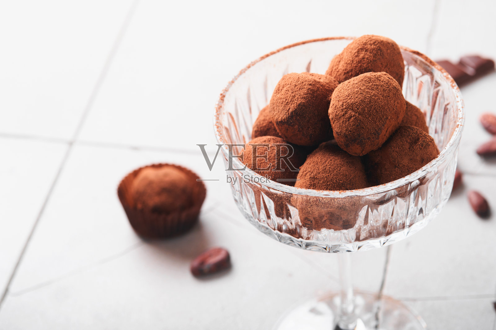 巧克力松露。自制松露巧克力与可可粉玻璃上的旧破裂瓷砖桌子的背景。美味甜美的巧克力松露糖果。情人节和母亲节的概念。照片摄影图片