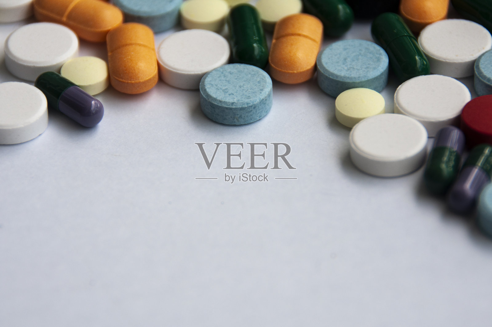 各种药物药丸,片剂和胶囊模糊的背景上的白色背景。医疗保健和医学的概念。照片摄影图片