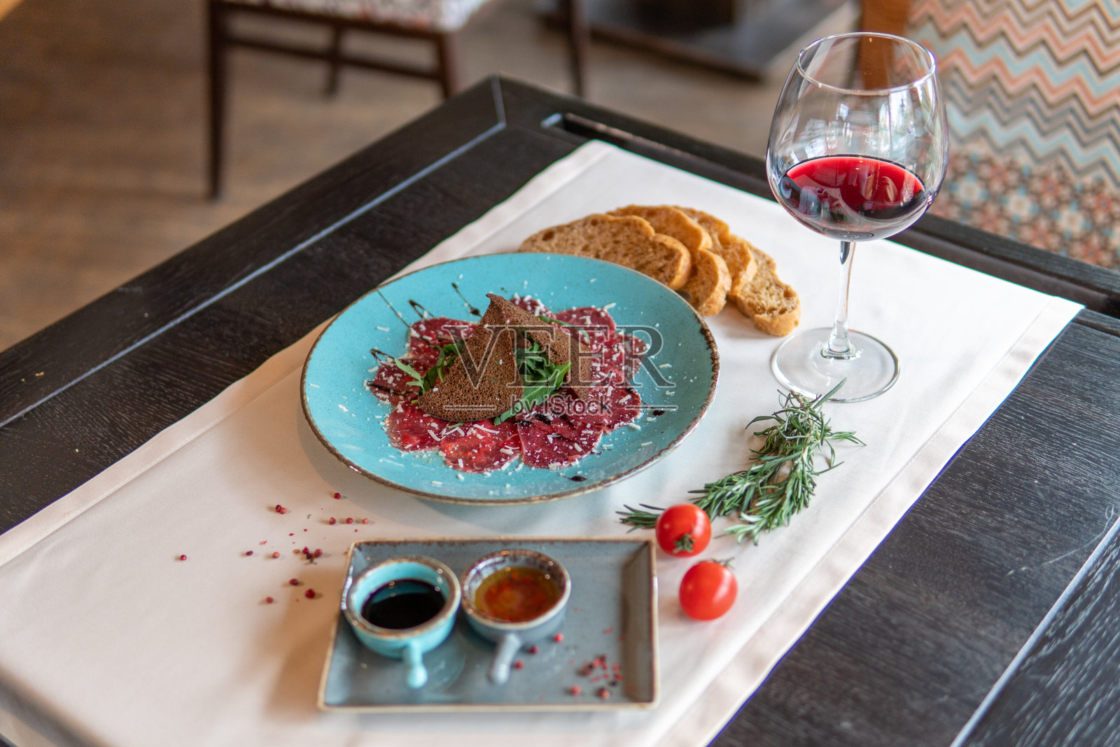 小牛肉片配黑面包片、橄榄油和第戎芥末照片摄影图片