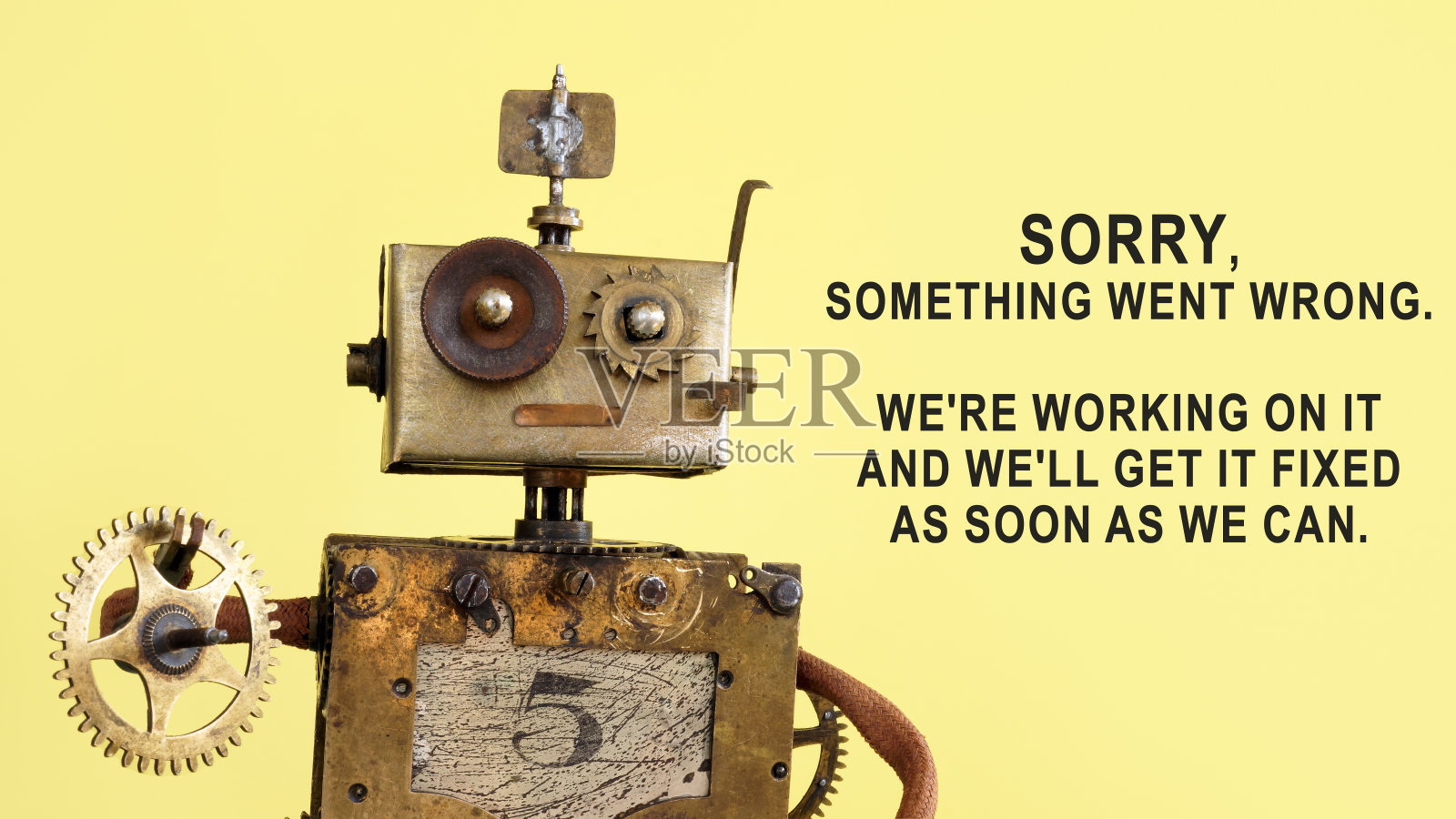 机器人拿着一个齿轮。有趣的404页。照片摄影图片