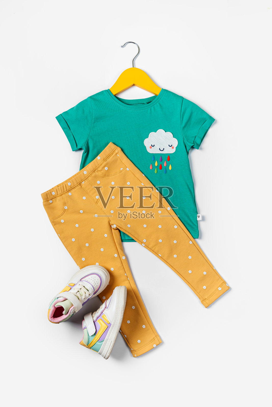 t恤配裤子和运动鞋。春天,秋天或夏天的婴儿衣服和配件的白色背景。时尚的孩子。平铺,俯视图照片摄影图片