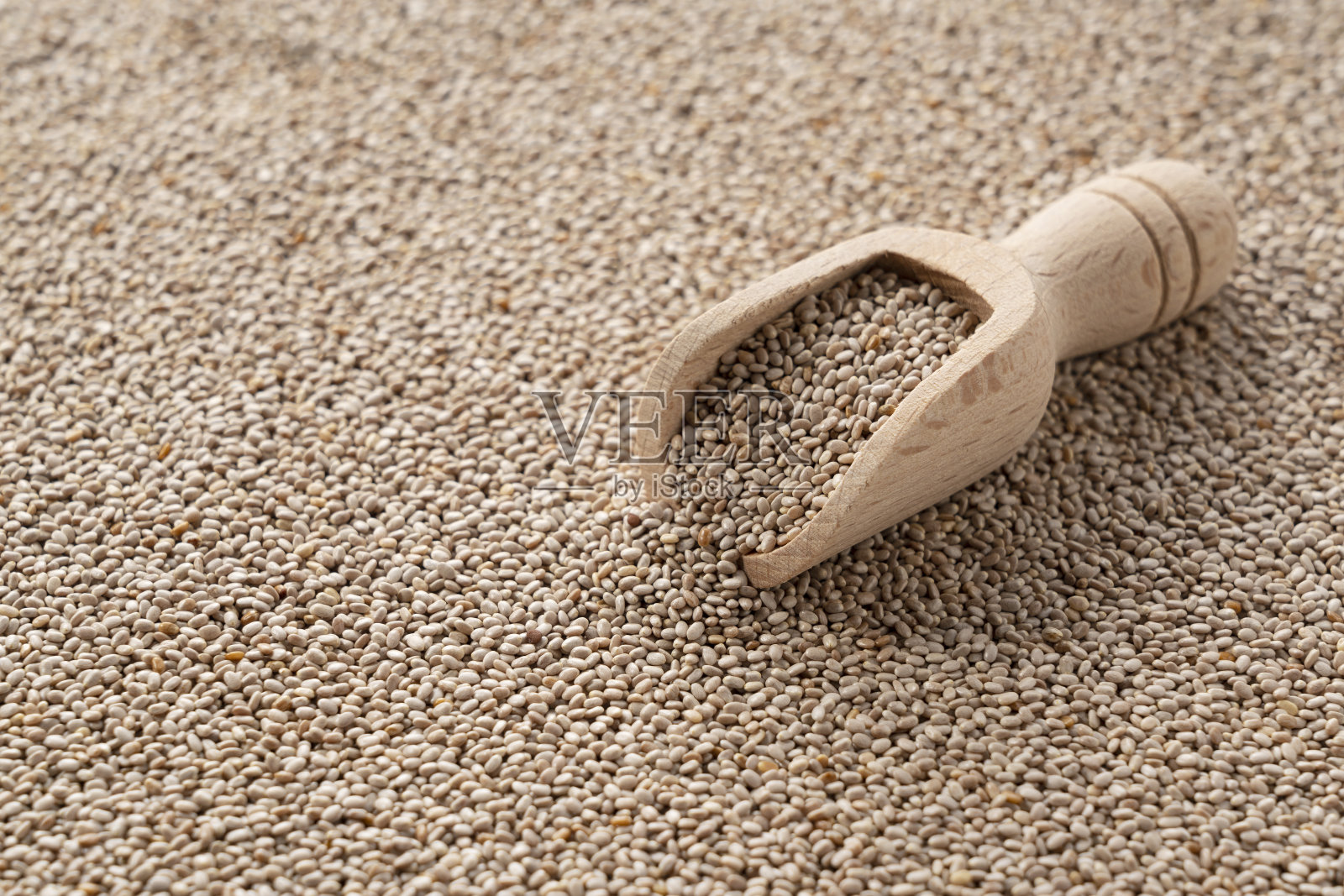 奇亚种子在屏幕上到处都是,在它们上面放一个木勺。照片摄影图片