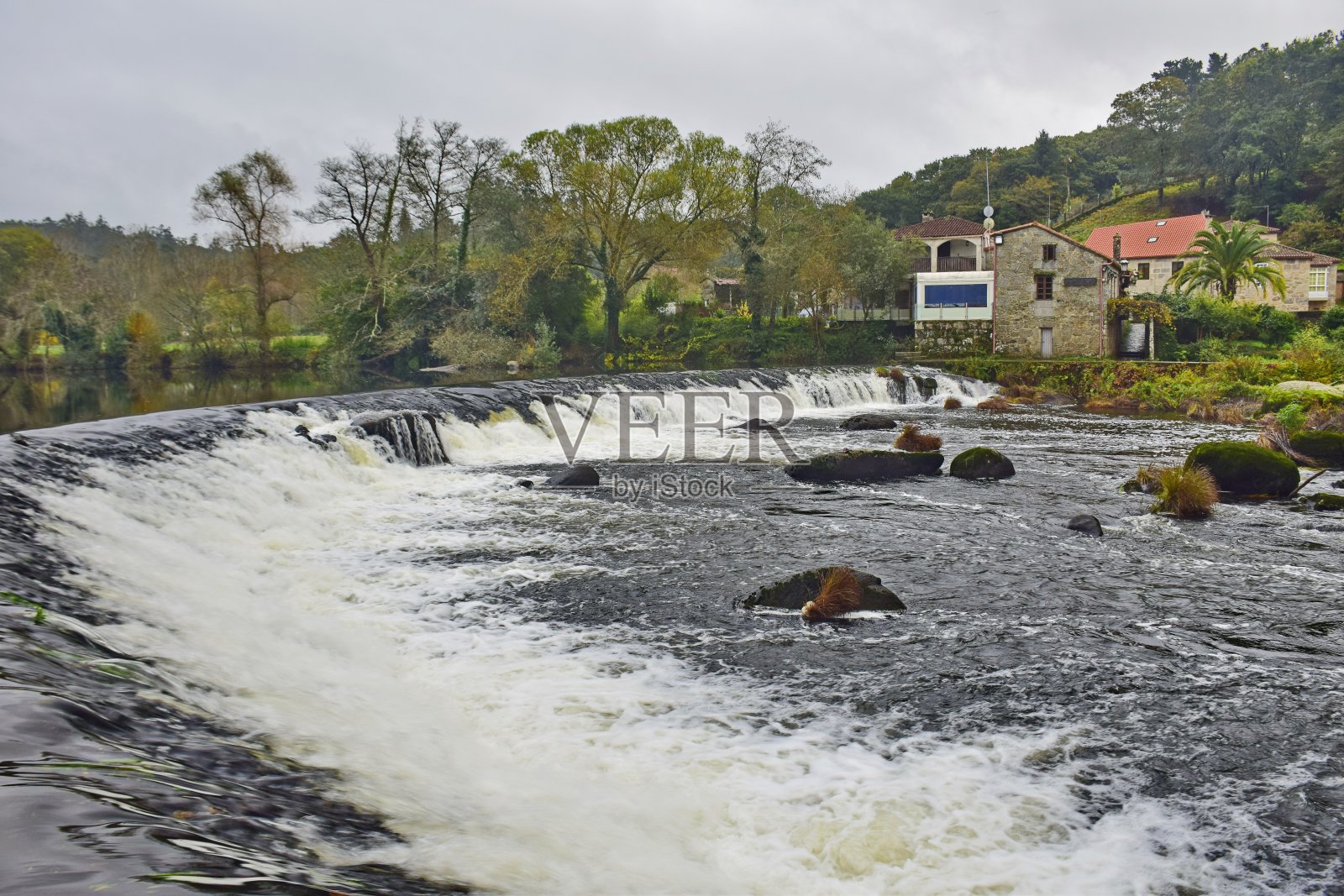 河上有一座古老的拱形石桥。圣詹姆斯之路,北路,西班牙。照片摄影图片