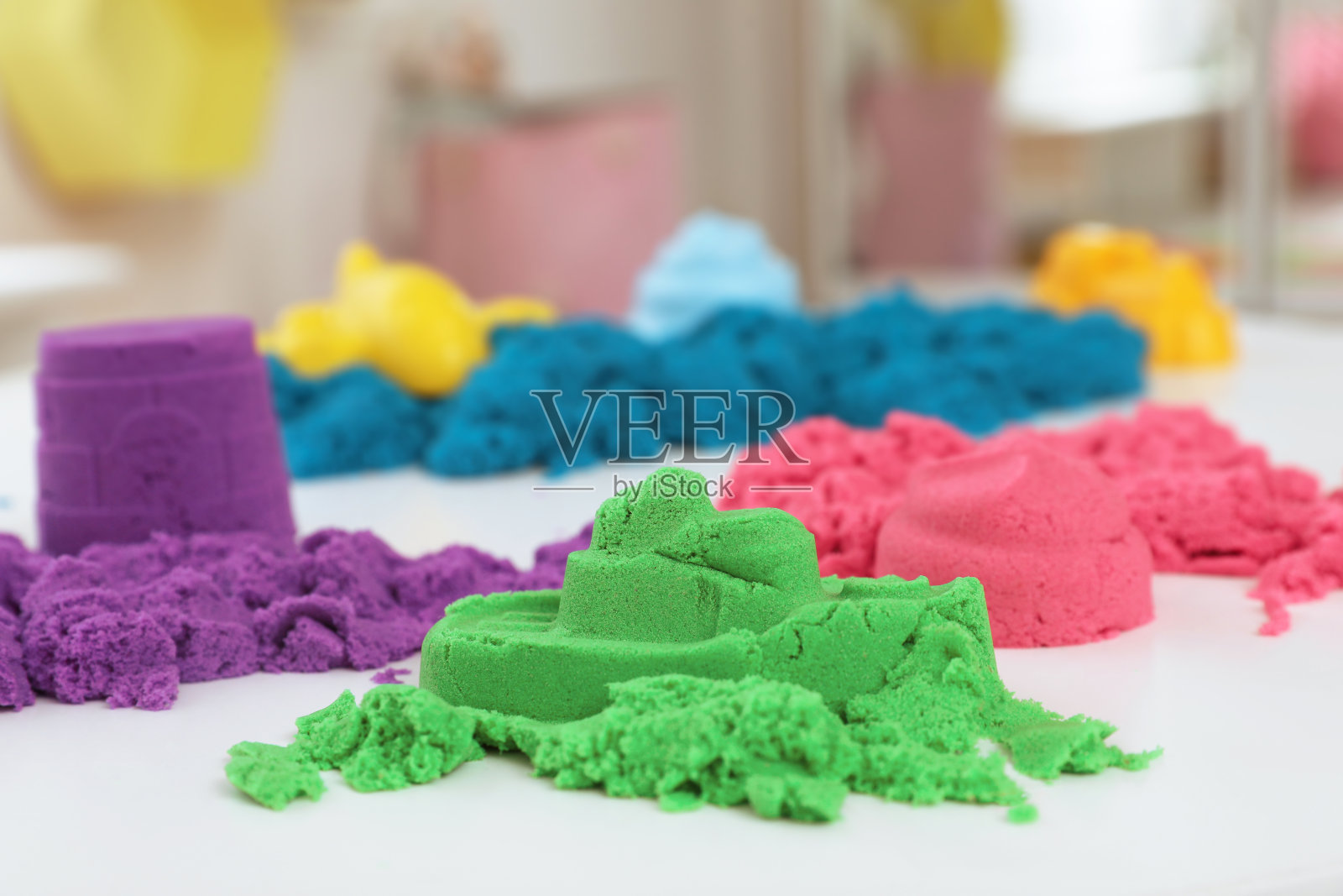 室内白色桌子上五颜六色的运动沙照片摄影图片