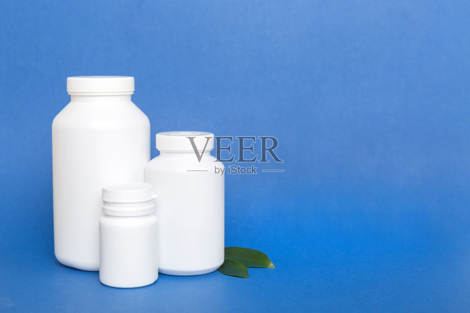 补充药丸用药瓶保健和医疗俯视图。维生素药片。俯视图模型瓶药片和维生素与绿叶,天然有机生物补充,复制空间照片摄影图片