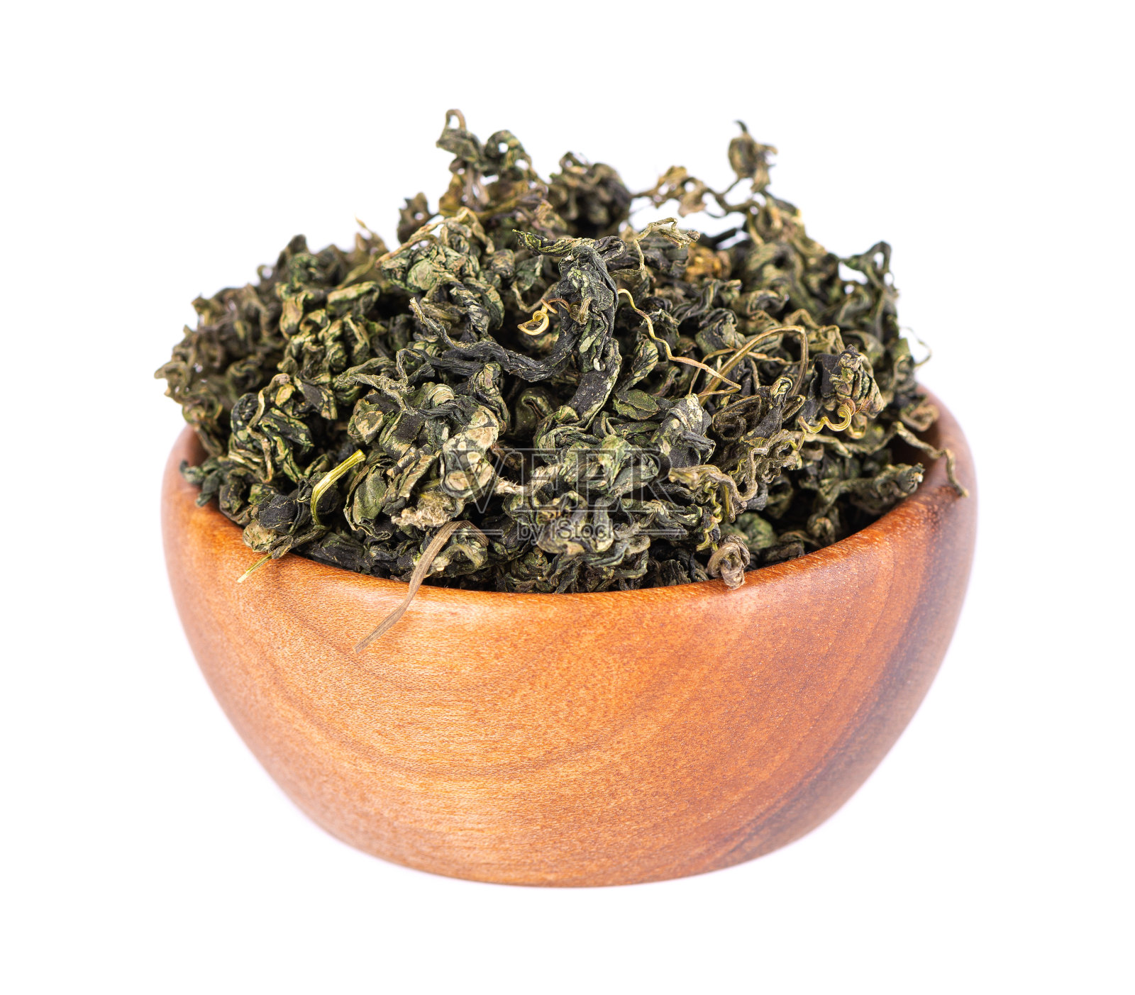 干燥绞股蓝叶在木碗里,离生在白色黑土上。焦谷兰或奇迹草。中国花草茶。照片摄影图片