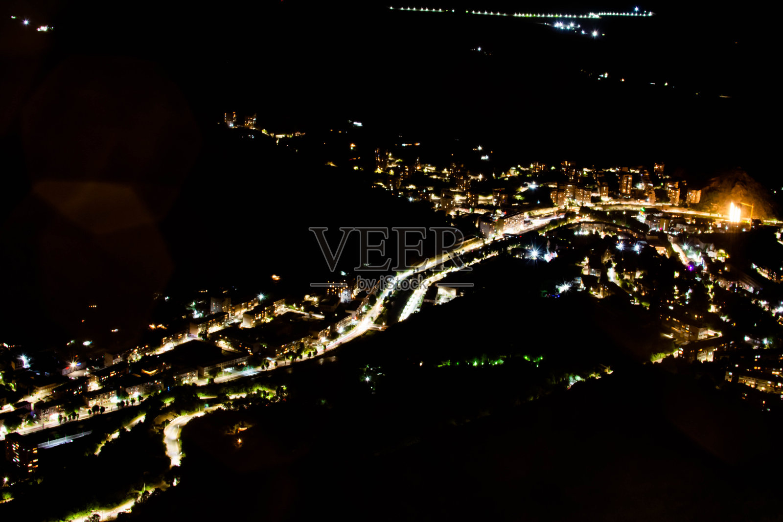 鸟瞰夜城。房子和汽车的灯光。一座美丽的城市,有河流、桥梁和美丽的建筑。卡潘,亚美尼亚,山中的城市照片摄影图片