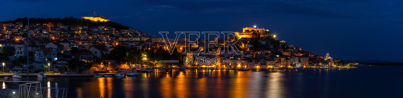在克罗地亚的西贝尼克,夜晚城市的灯光反射,全景拍摄照片摄影图片