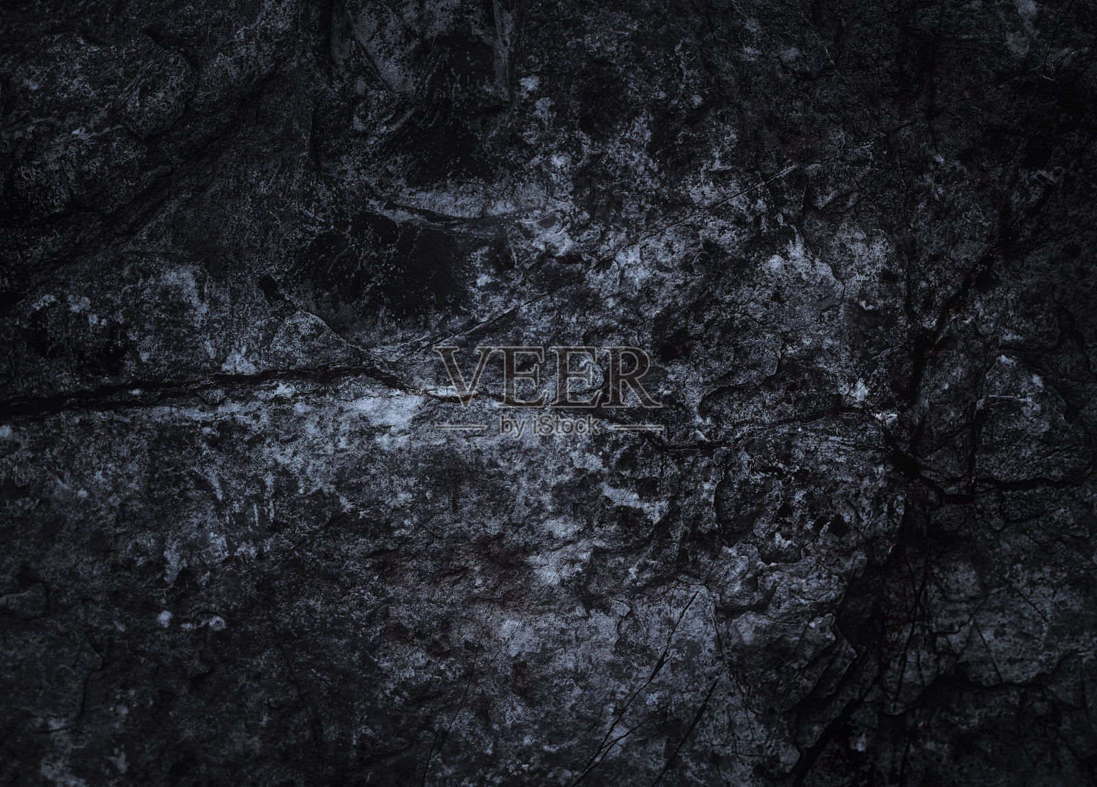 岩石表面有裂缝。黑色的纹理。石头的背景。黑暗的大理石。岩石纹理。岩石堆。墙漆点。枯燥乏味的粗糙结构。抽象的纹理。照片摄影图片