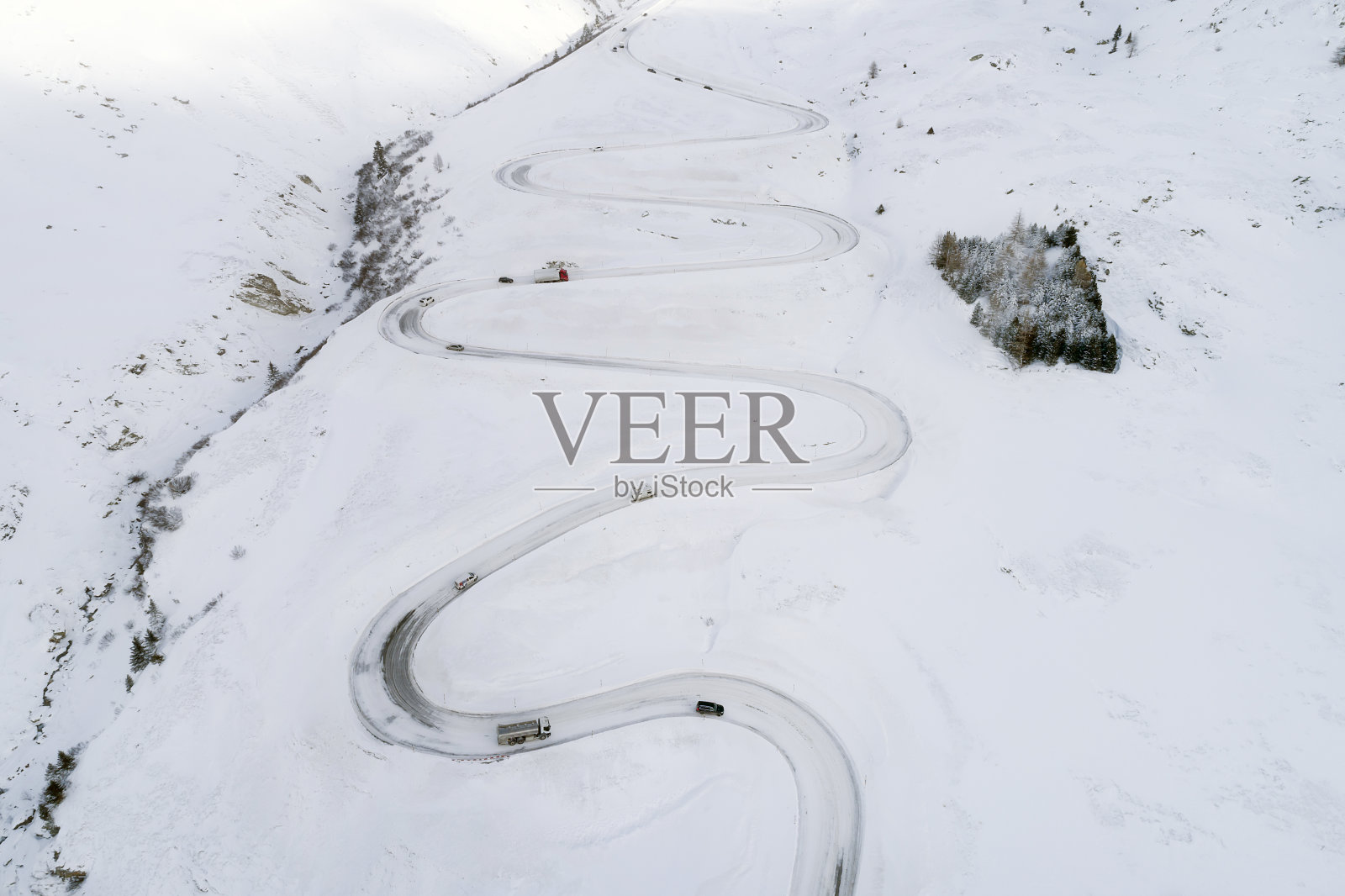 冬季山路上的交通,瑞士阿尔卑斯山,鸟瞰图照片摄影图片
