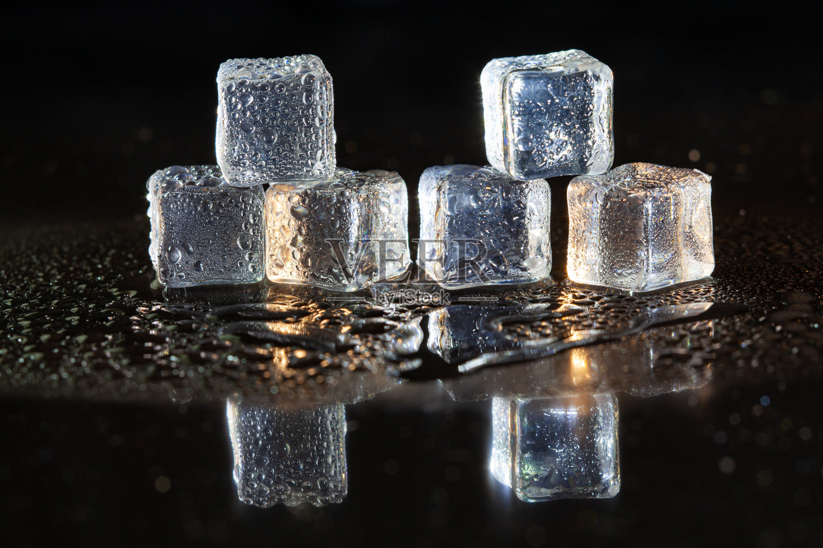 黑色桌子背景上的冰块。照片摄影图片