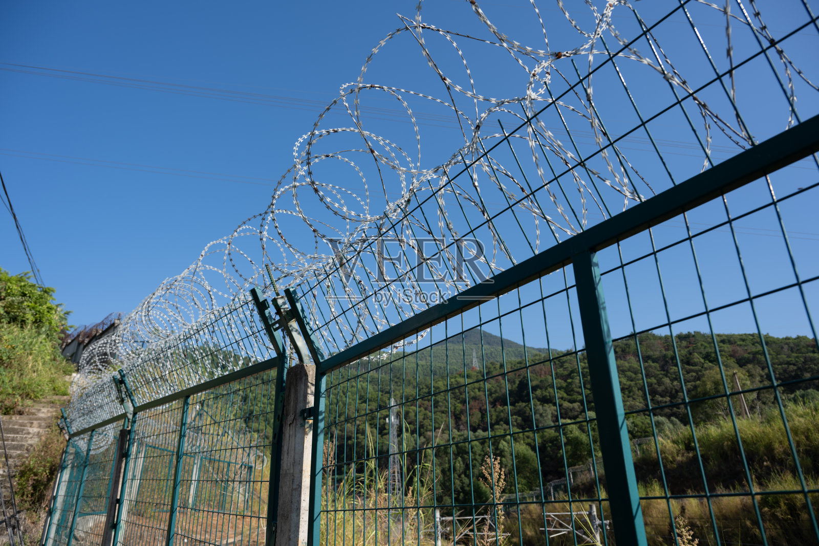 带铁丝网的金属栅栏照片摄影图片