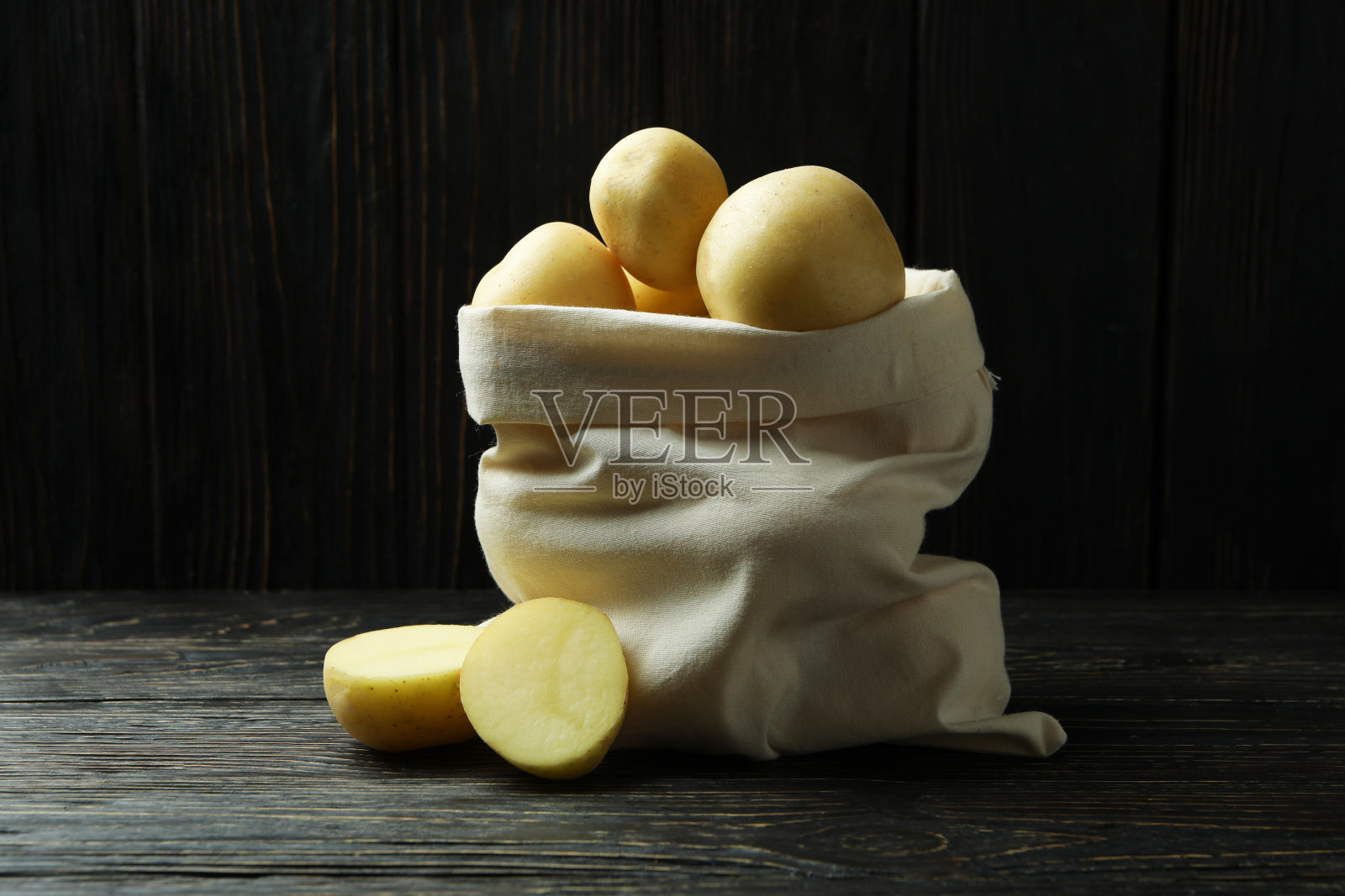 木桌上放着一袋小土豆照片摄影图片