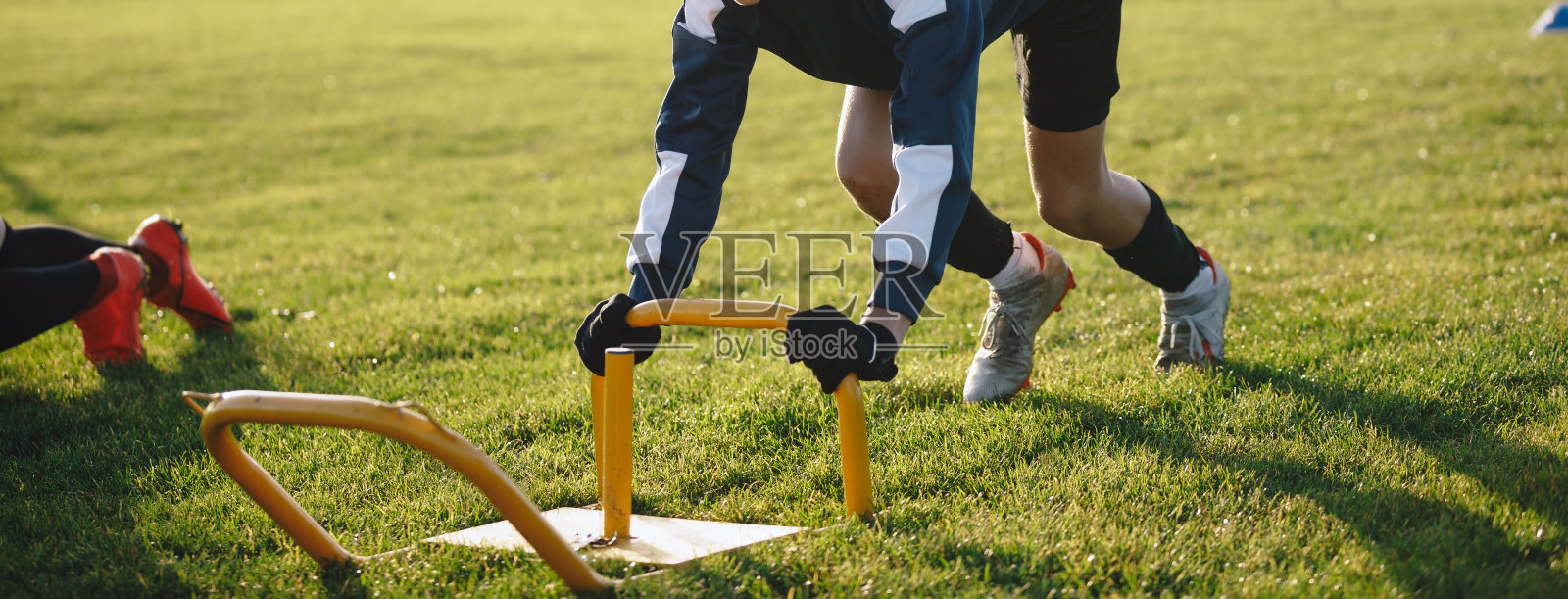 十几岁的男孩在户外进行足球力量训练。小男孩向前推东西,跑得很快。秋季足球训练照片摄影图片