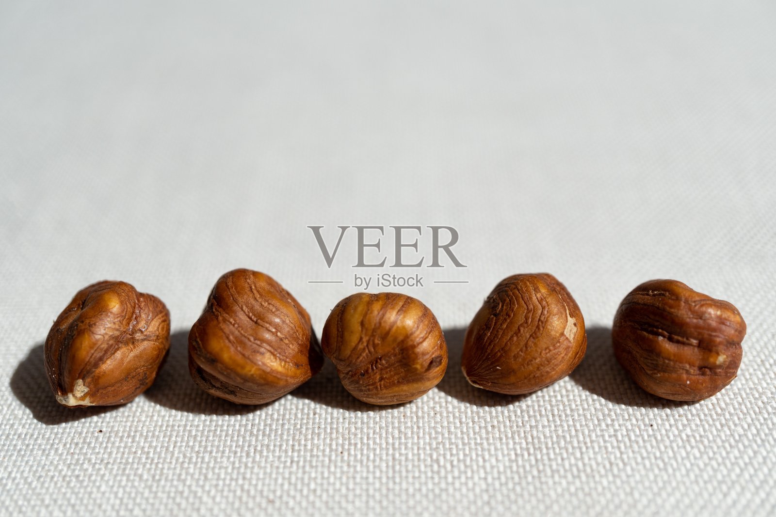 白色表面上的五个榛果的特写镜头照片摄影图片