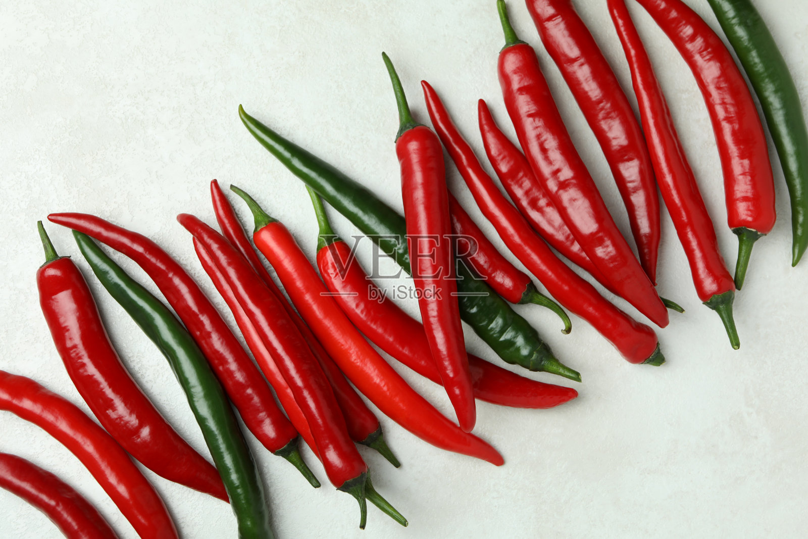 红色和绿色的辣椒在白色的纹理背景照片摄影图片