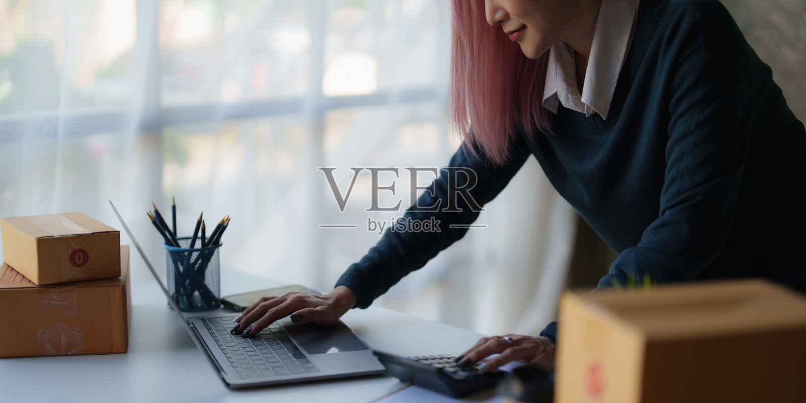 创业小型企业的自由职业亚洲女性使用笔记本电脑与盒子快乐的成功亚洲女性她的手举起网上营销包装盒和配送中小企业的想法概念照片摄影图片