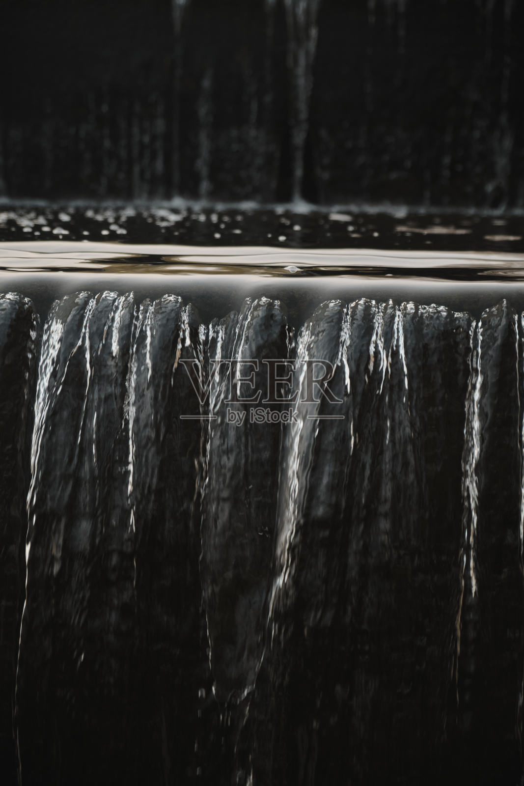 瀑布流在公园的水墙一个美丽的瀑布瀑布的城市喷泉特写倒照片摄影图片