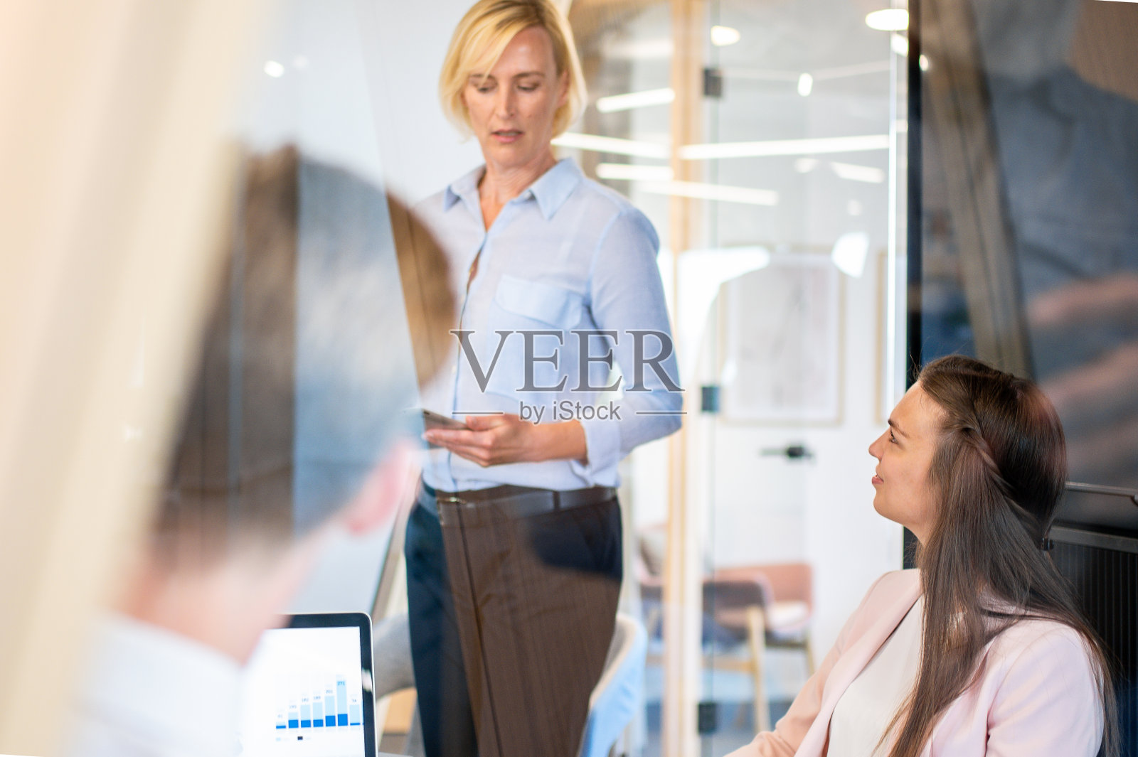 在一个现代化的初创公司办公室和会议室里,同事们就问题进行头脑风暴。照片摄影图片