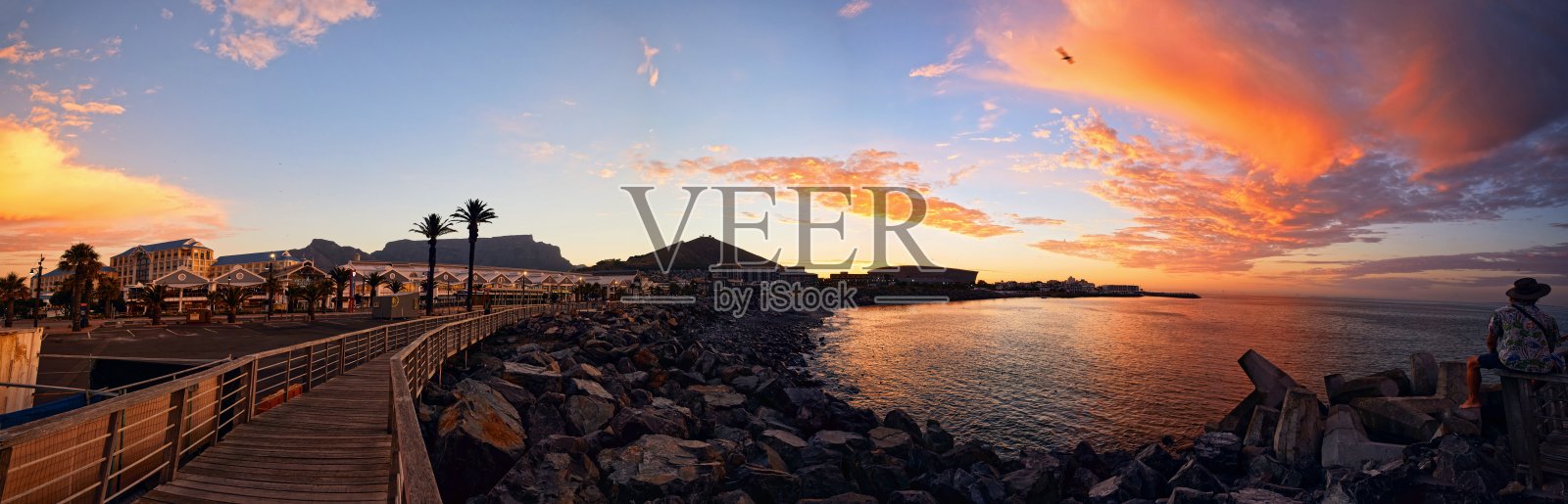 南非开普敦,日落时分岩石海岸的木制走道全景照片照片摄影图片