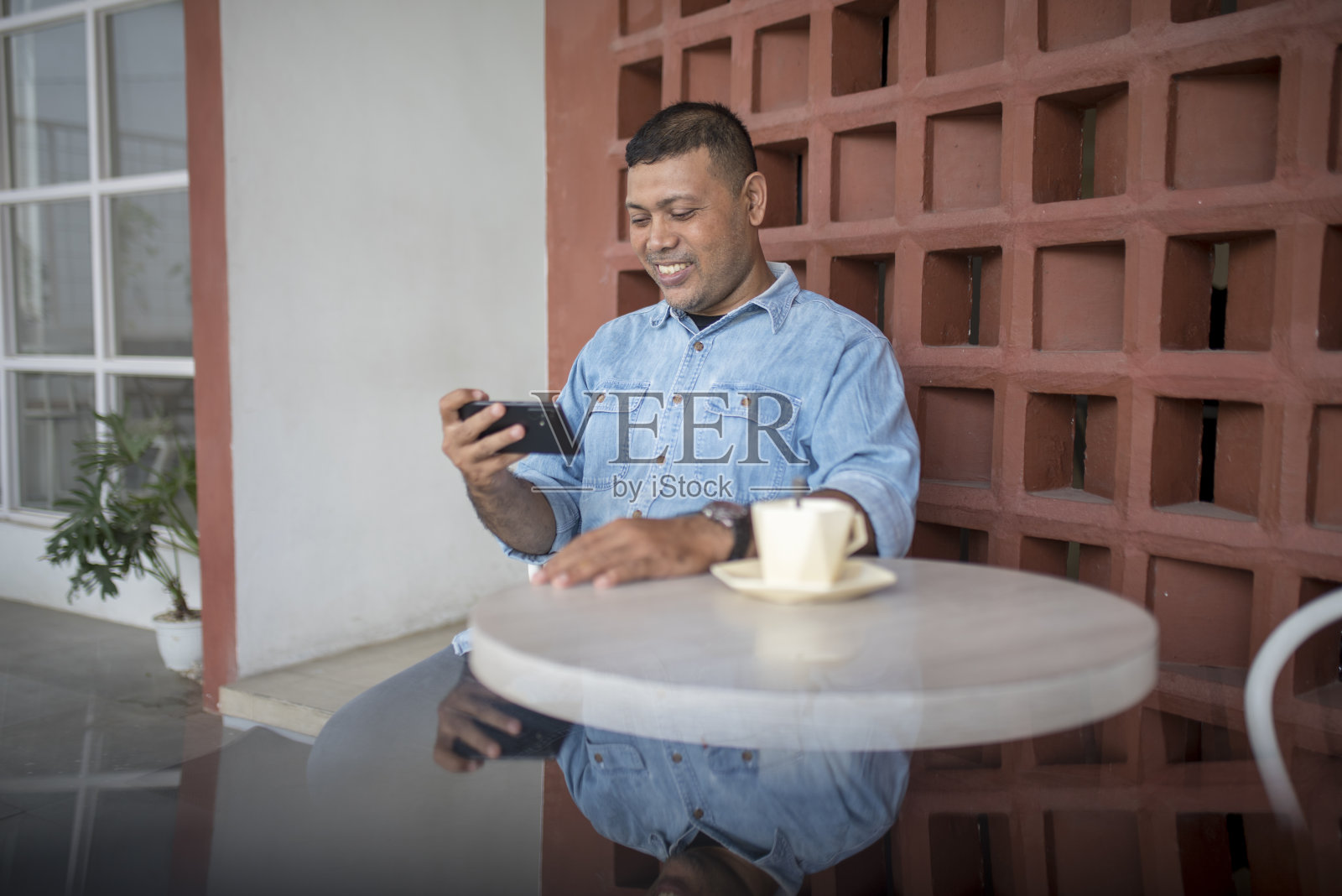 亚洲男子看智能手机照片摄影图片