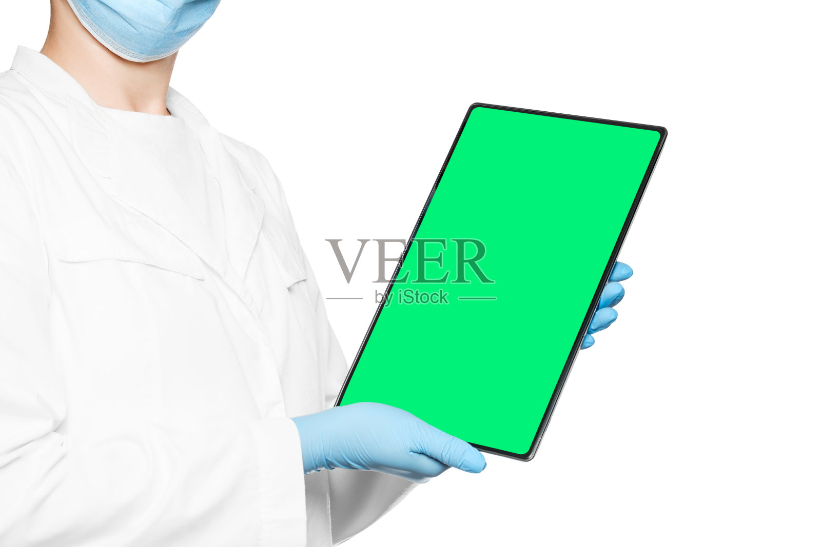 医生手里拿着一块空白的电子平板,屏幕是绿色的。照片摄影图片