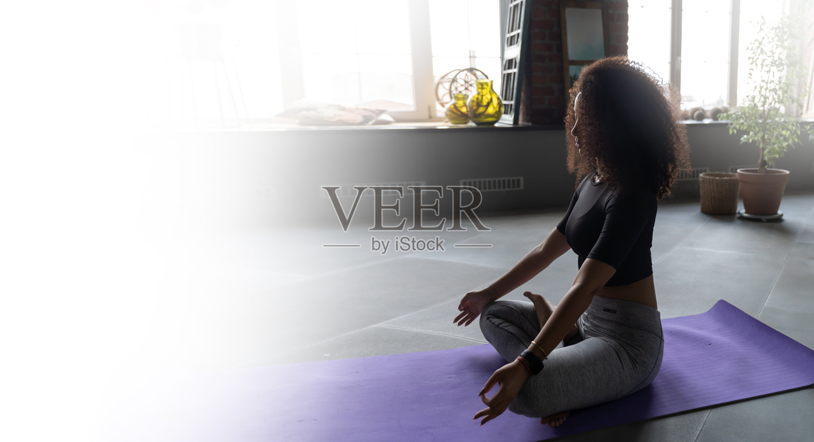 年轻的巴西女子练习瑜伽在放松的位置,而坐在健身房健身工作室的垫子上,放松和冥想的概念照片摄影图片