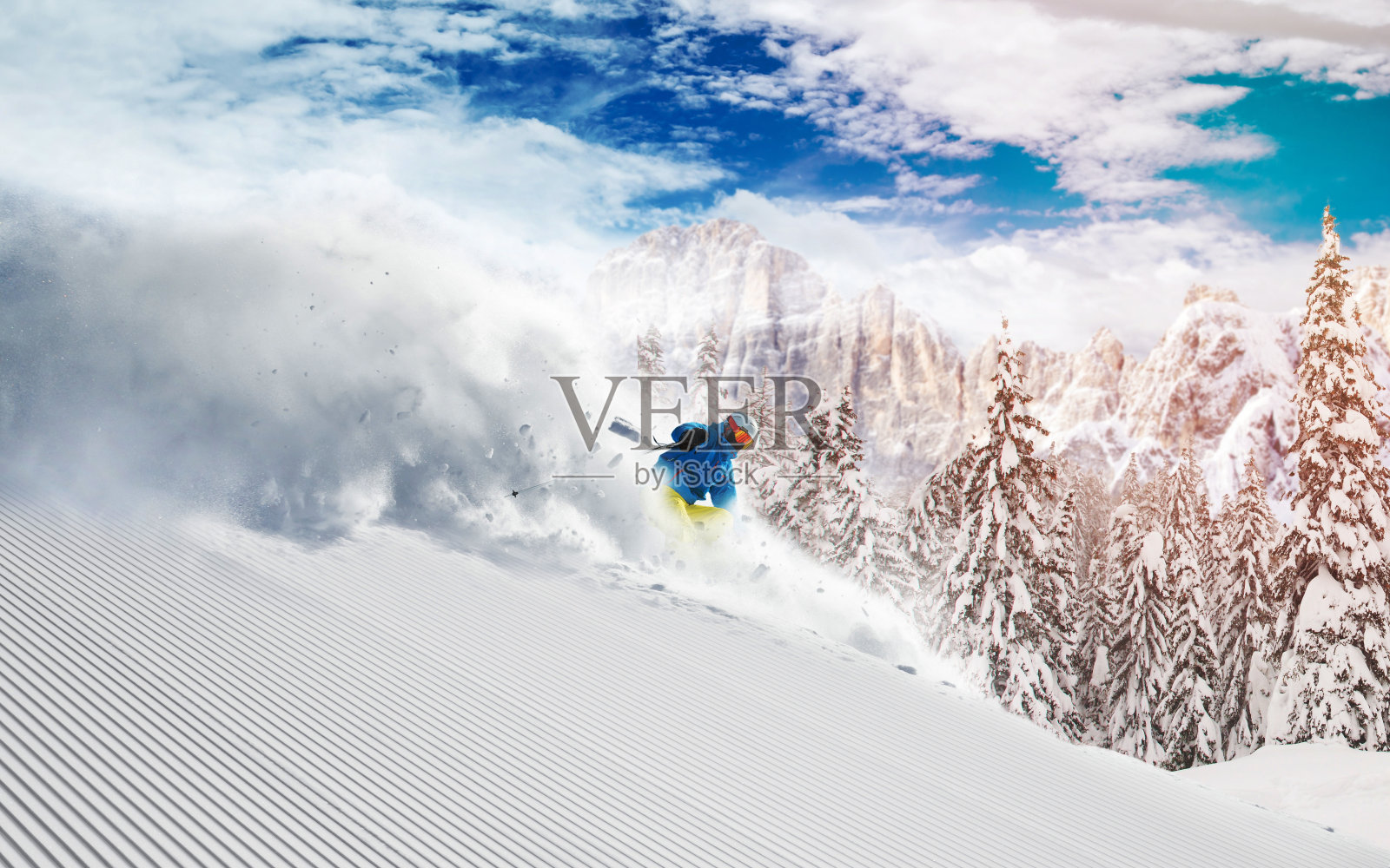 滑雪者在高山中向下滑雪照片摄影图片