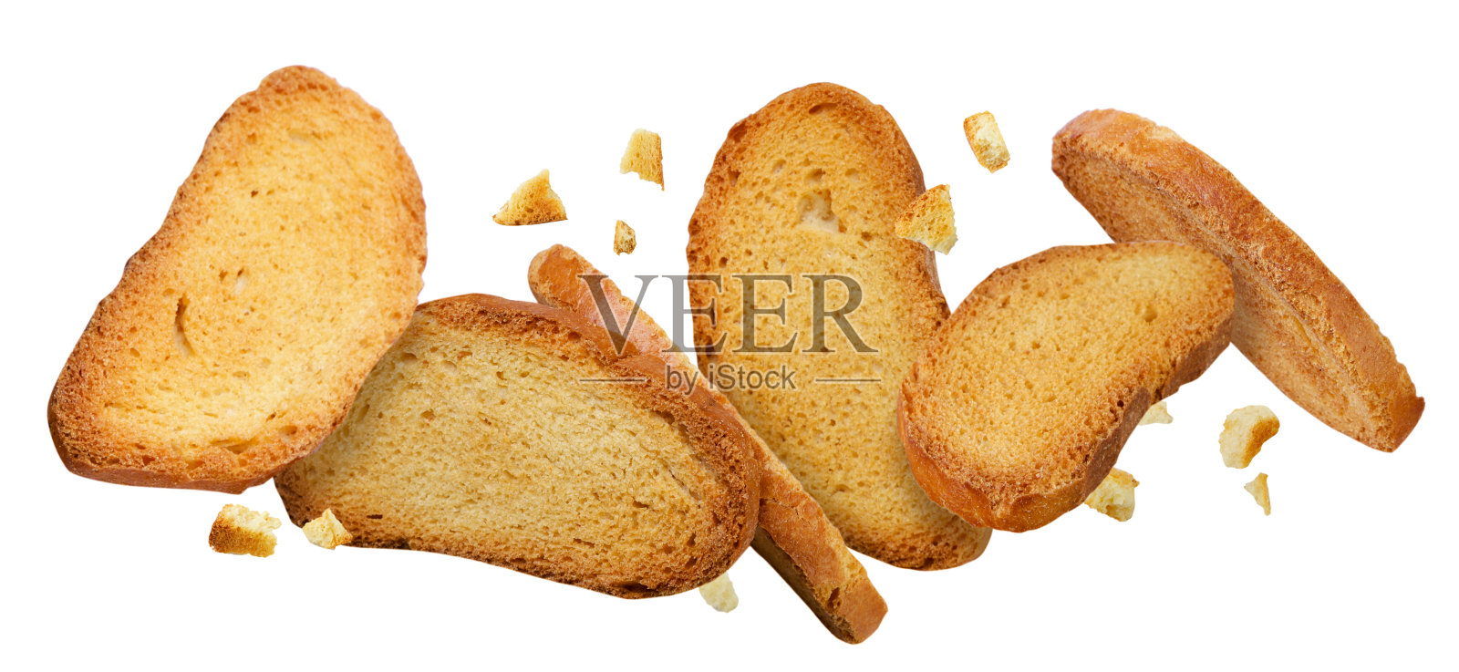 面包干和面包屑在白色的背景上飞舞。照片摄影图片
