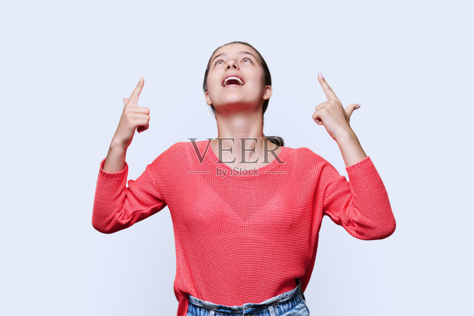 年轻女子指着手指,白色背景上的空白文字照片摄影图片