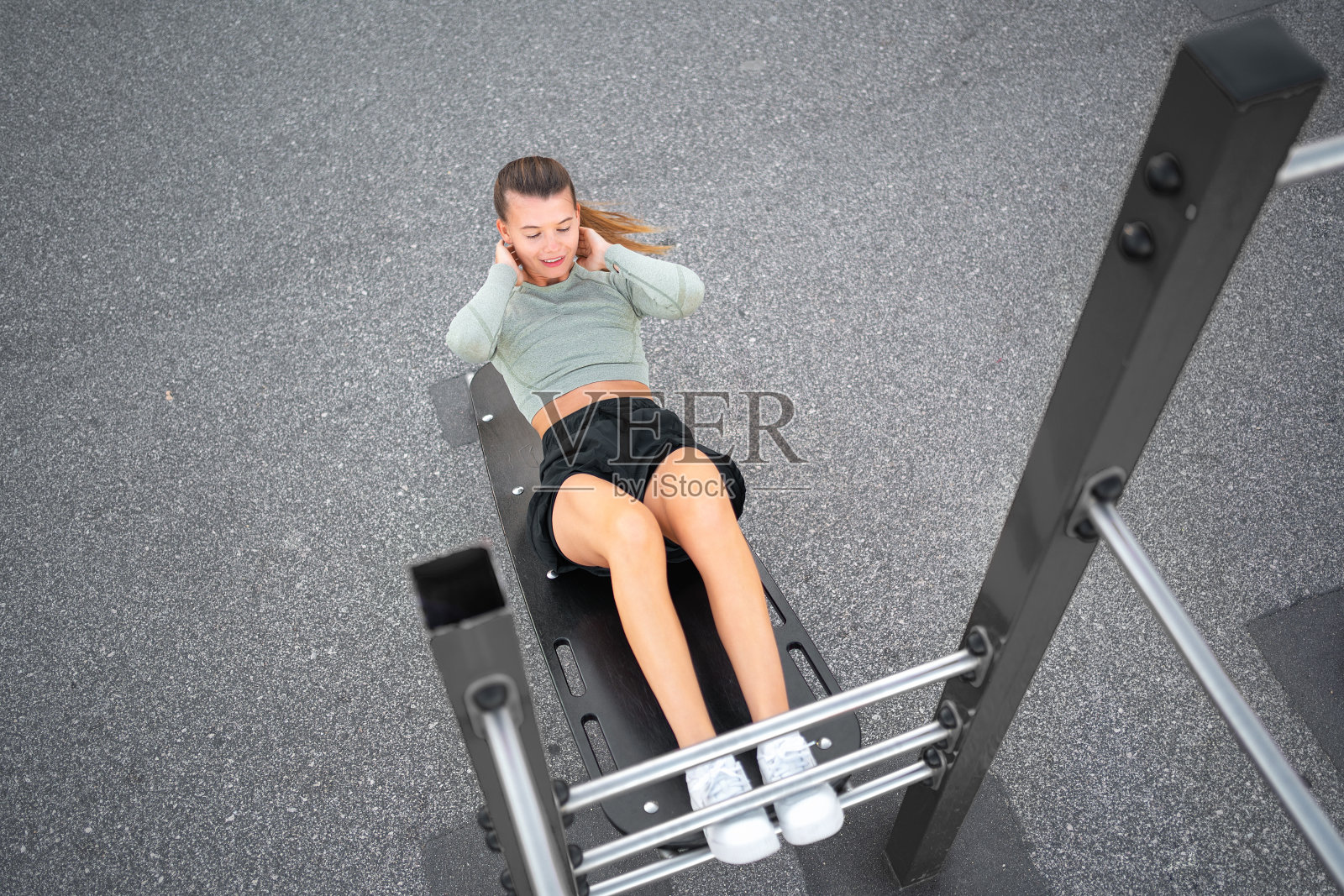 仰卧起坐练习。积极,健康的运动女性做仰卧起坐,锻炼和训练健身户外健身房照片摄影图片