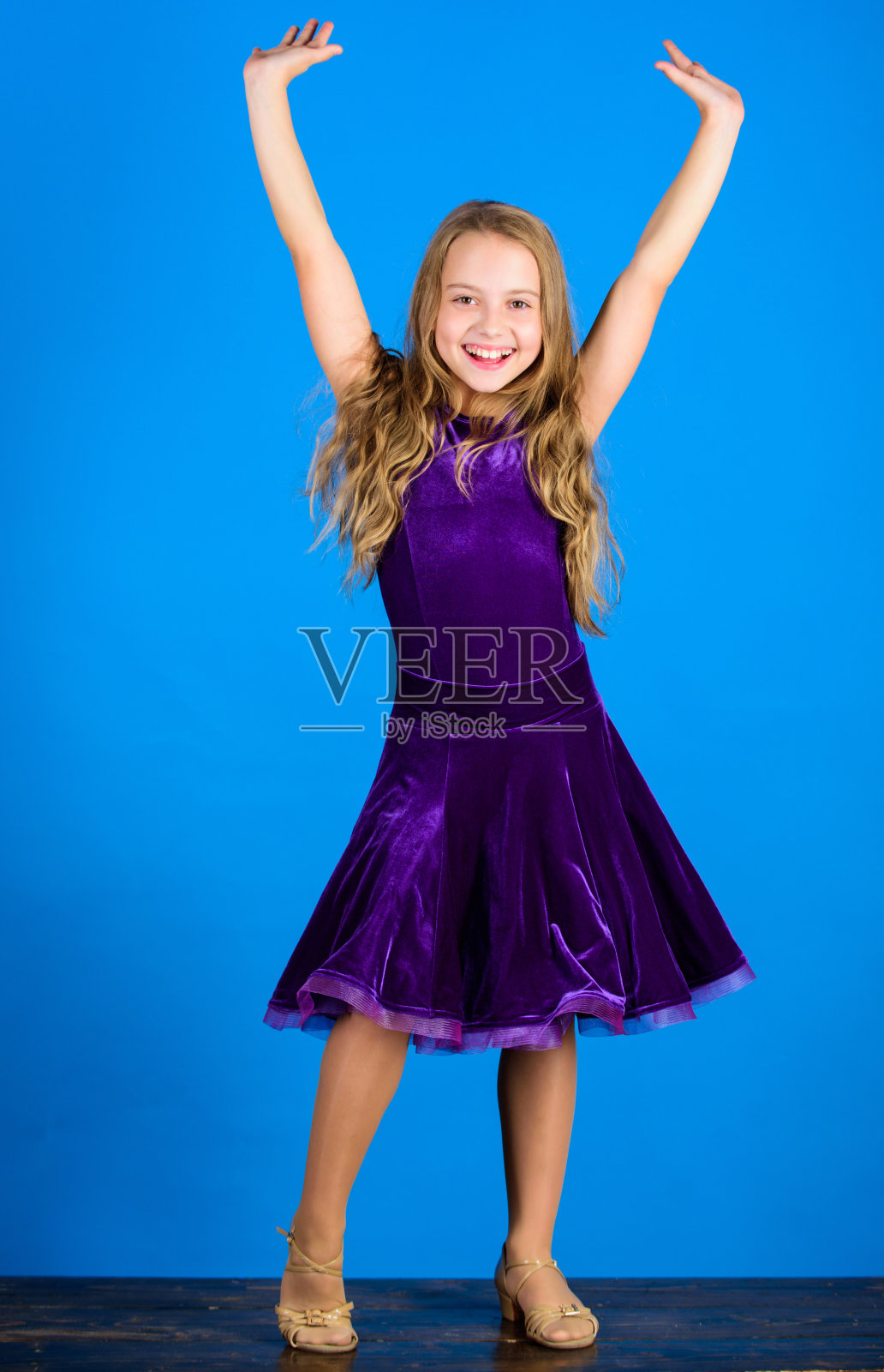 童装看起来很可爱。交际舞服装的时尚概念。对演唱会服装满意的童装舞者。交际舞的服装。舞厅时尚。女孩穿天鹅绒紫色连衣裙照片摄影图片