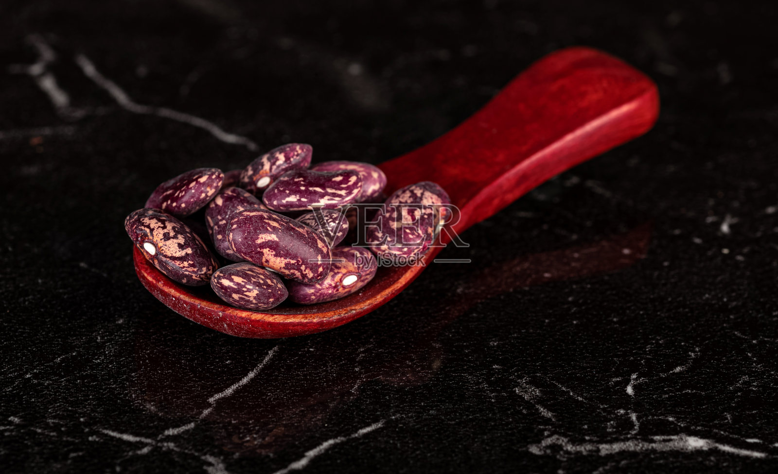 豆粒装在漂亮的木勺里照片摄影图片