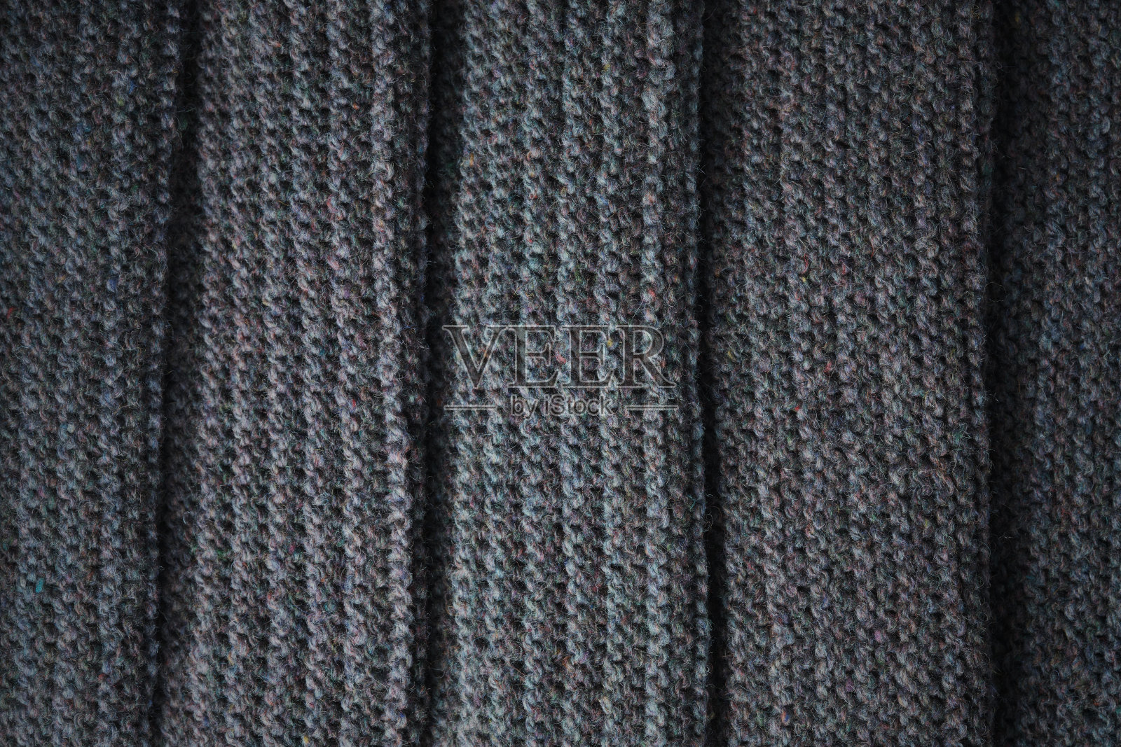 黑色针织物的褶皱。针织纹理背景。照片摄影图片