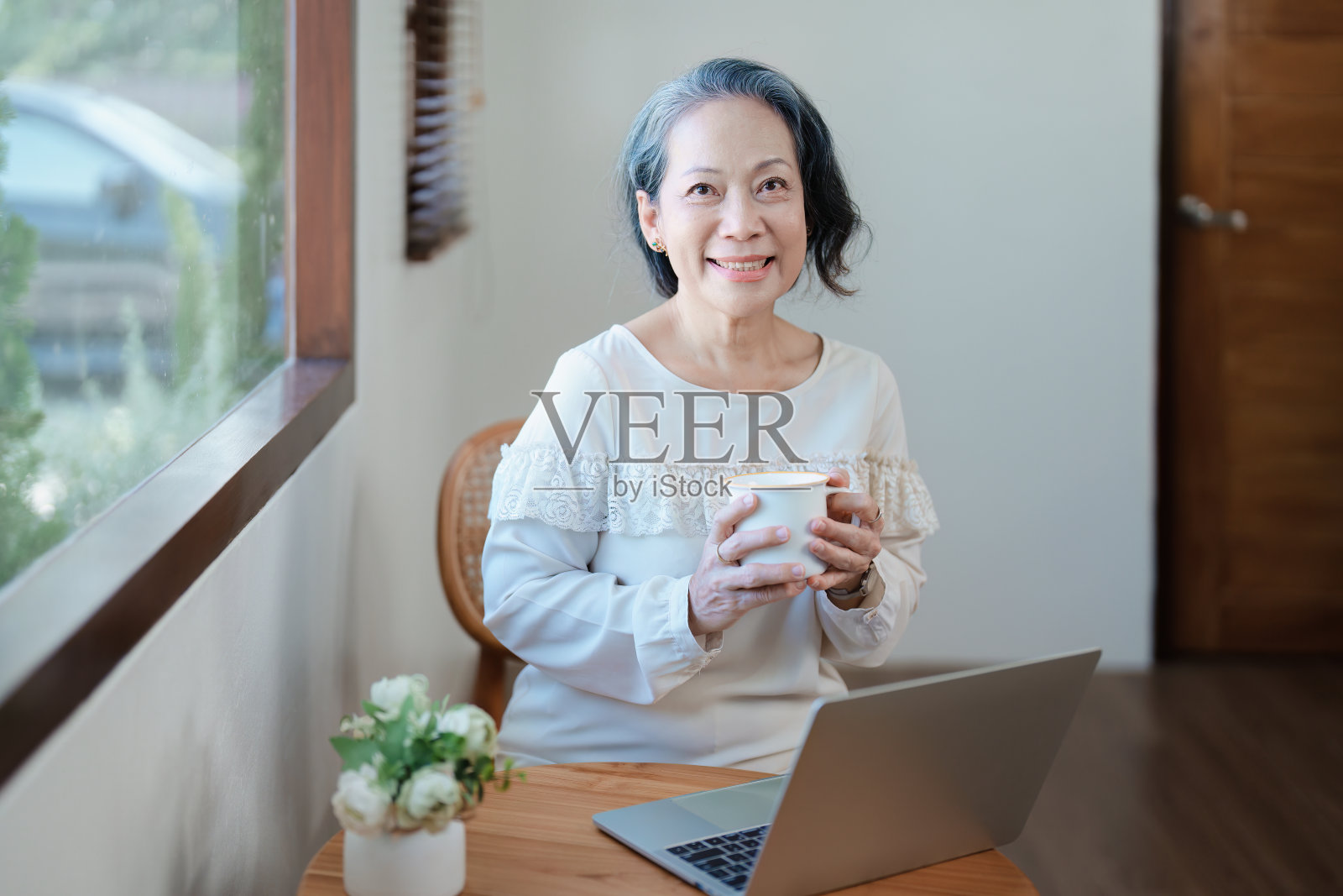 做电脑工作喝咖啡的亚洲老年妇女肖像照片摄影图片