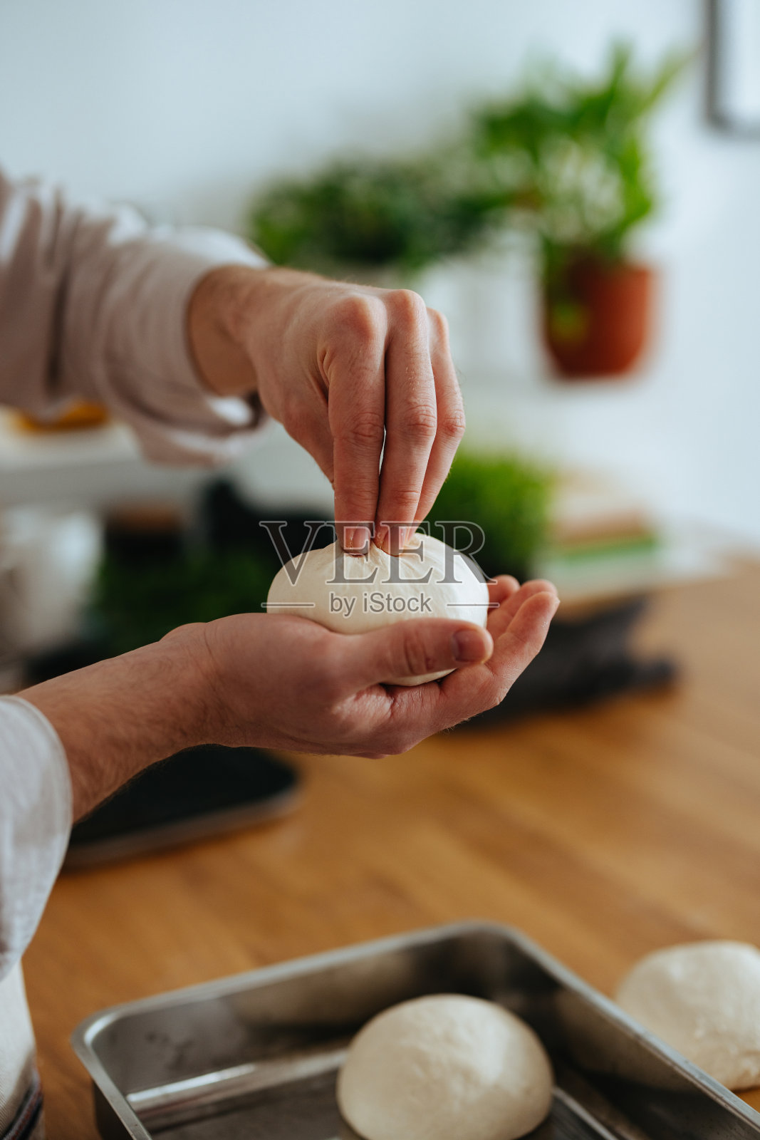 匿名男子在手里捏着一个生面团球照片摄影图片