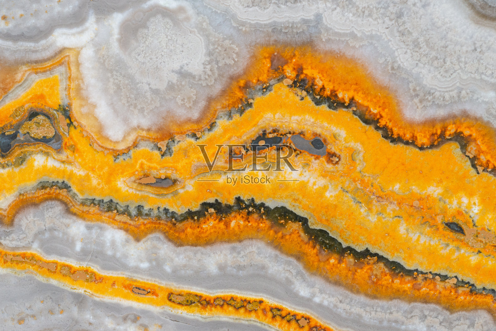 大黄蜂贾斯帕。日落碧玉。日蚀贾斯珀。能量石。一种天然矿物,其纹理上有特有的黄色条纹照片摄影图片