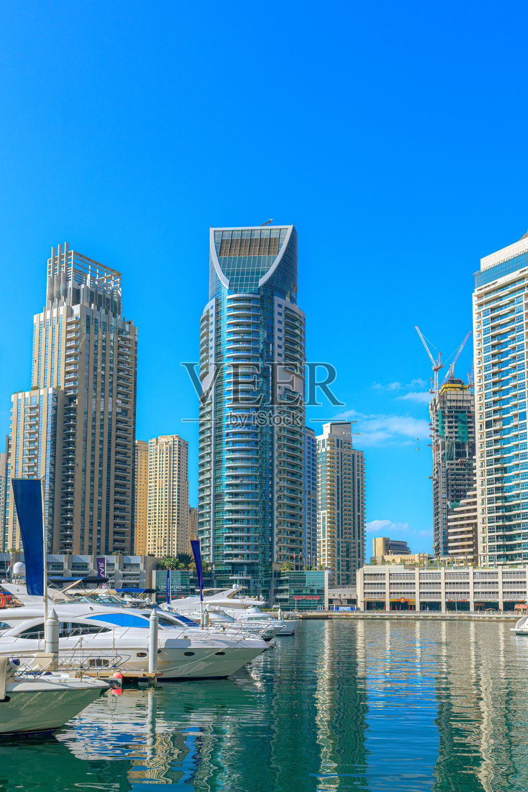 阿拉伯联合酋长国迪拜码头:停泊的船只与高耸的海滨摩天大楼照片摄影图片